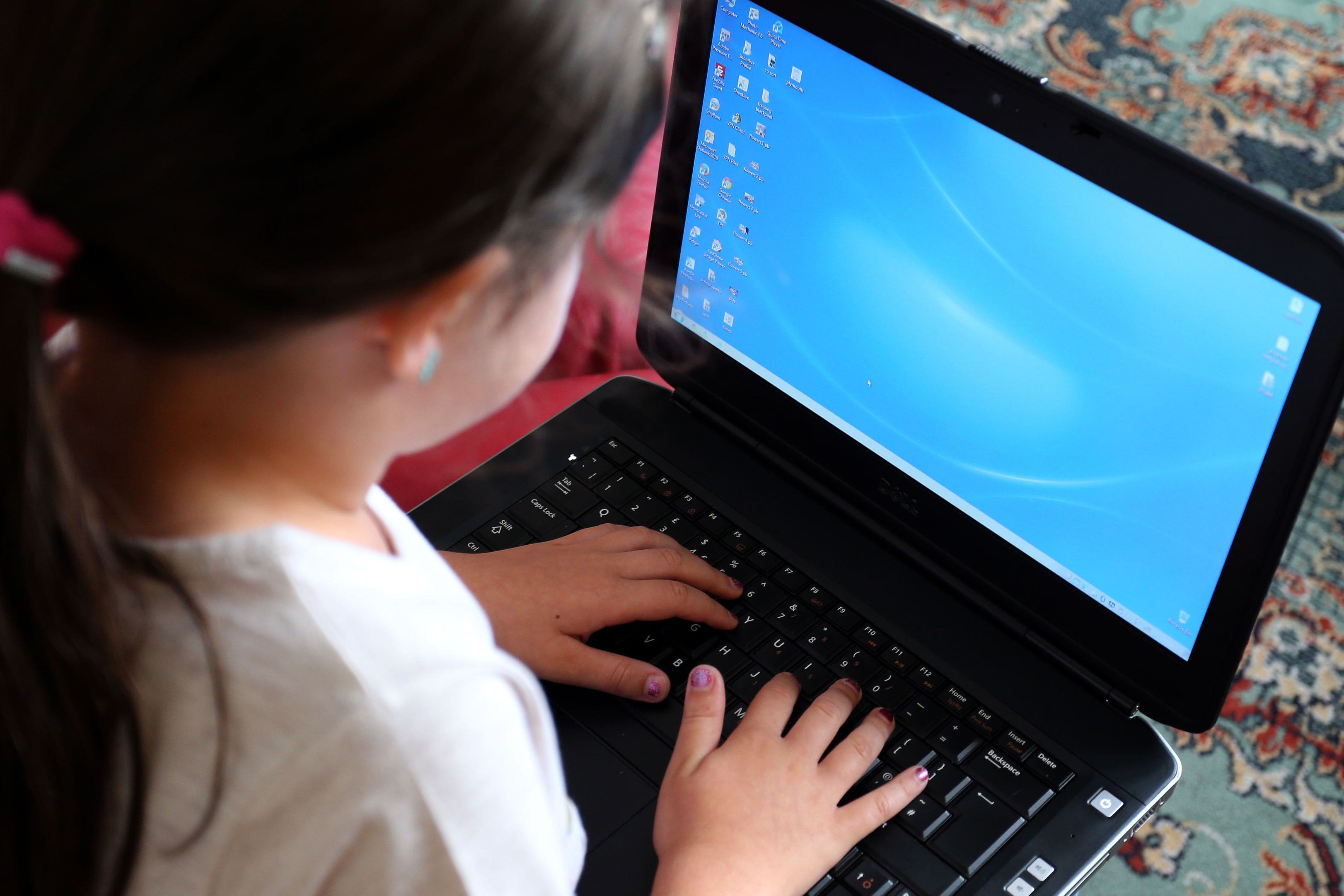 File photo dated 21/08/14 of a child using a laptop computer. Schoolchildren in the UK are now using AI to generate indecent images of other children, internet safety groups have warned. The UK Safer Internet Centre (UKSIC) said it has begun receiving reports from schools that children are making, or attempting to make indecent images of other children using AI image generators. Issue date: Monday November 27, 2023.
