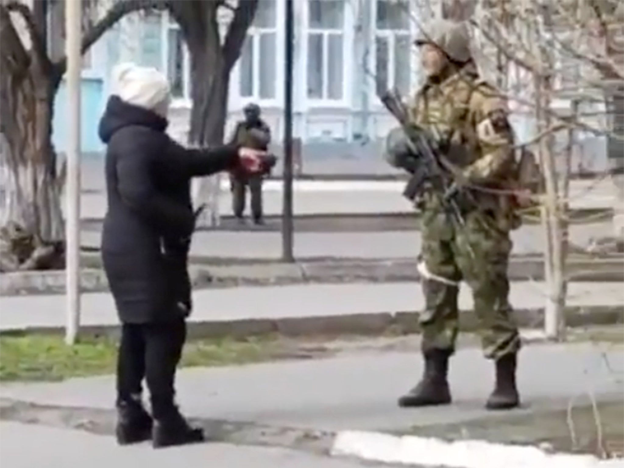 A Ukrainian woman confronts a Russian soldier in Henichesk during the first days of the invasion in March 2022