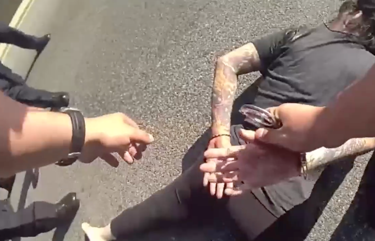 Body cam footage shows police handcuffing Jennifer Lauren as she lies on the ground after she was shot. Lauren has since posted bail