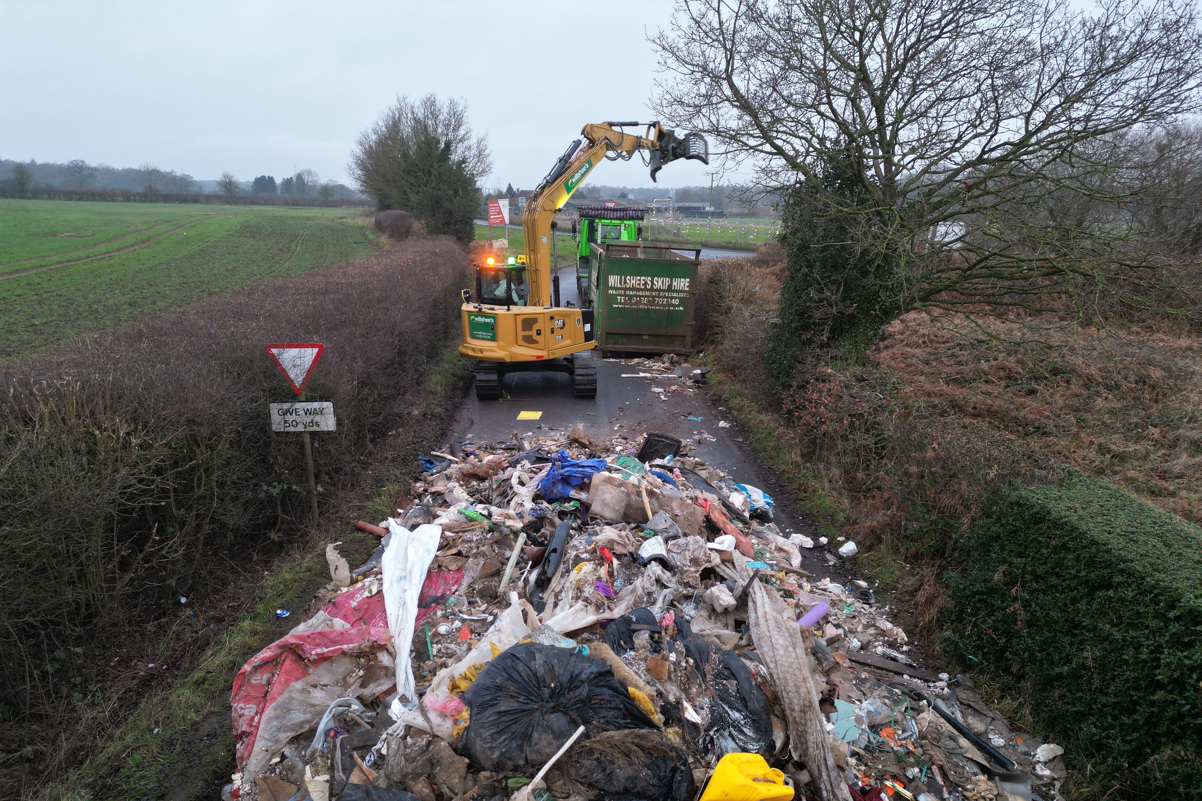 Contractors work to remove a pile of waste from Watery Lane, Staffordshire (Phil Barnett/PA)