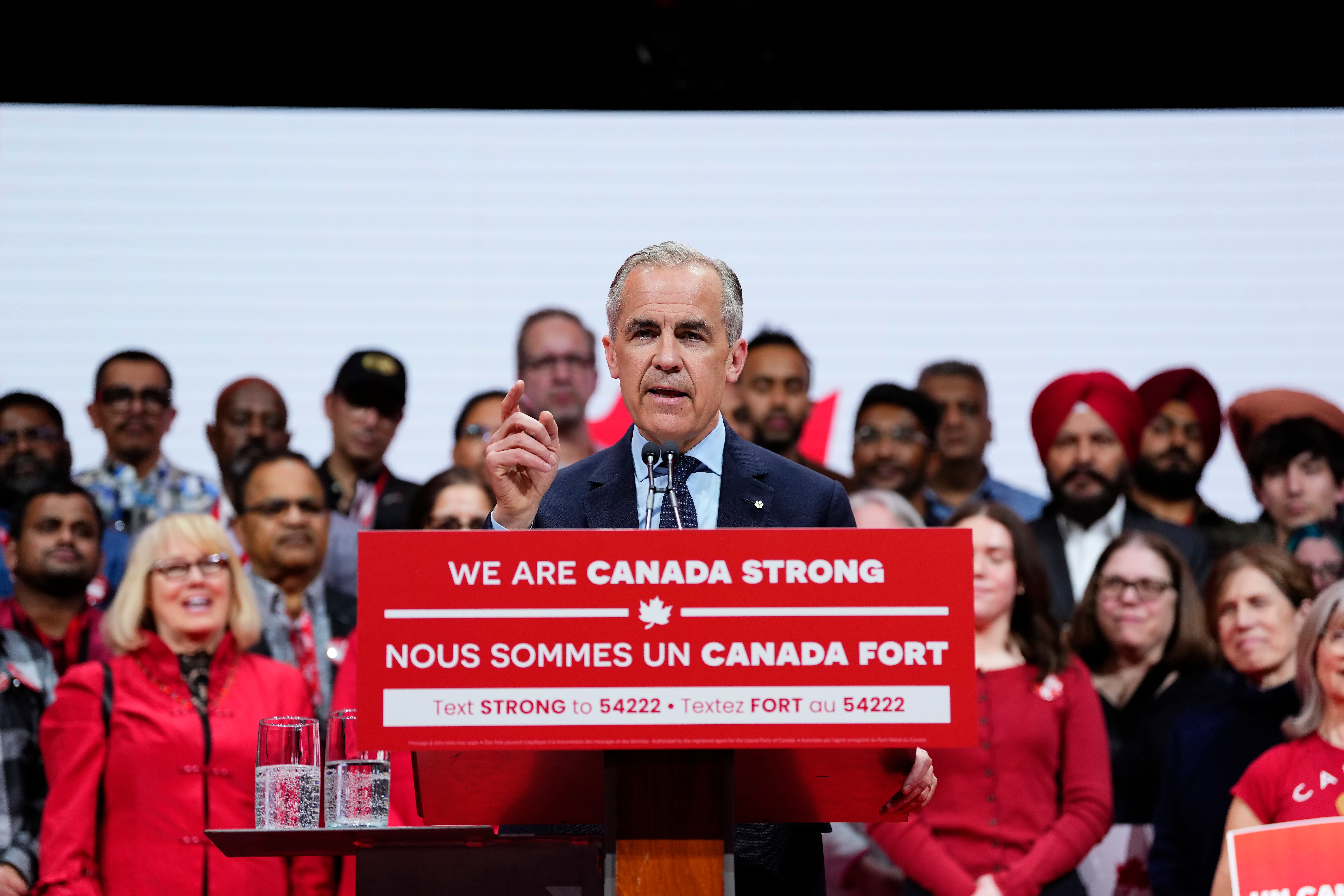 Canadian prime minister Mark Carney speaks to supporters on stage at his campaign headquarters after the Liberal Party won