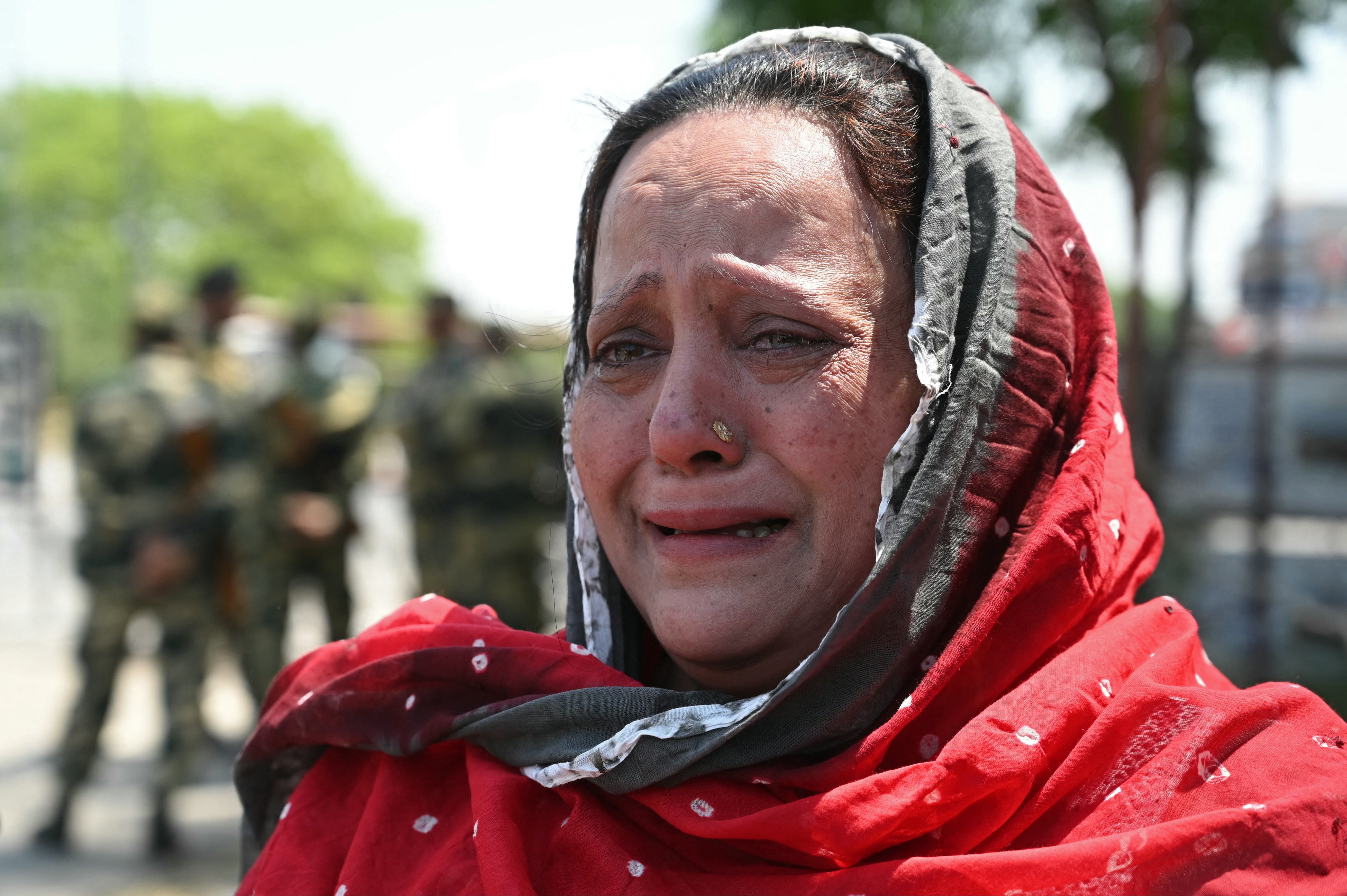 Robina, an Indian citizen weeps as she waits for her brother Imran Ali, an Indian citizen and her sister-in-law Giza, a Pakistani citizen, at the India-Pakistan Wagah border post, about 35kms from Amritsar