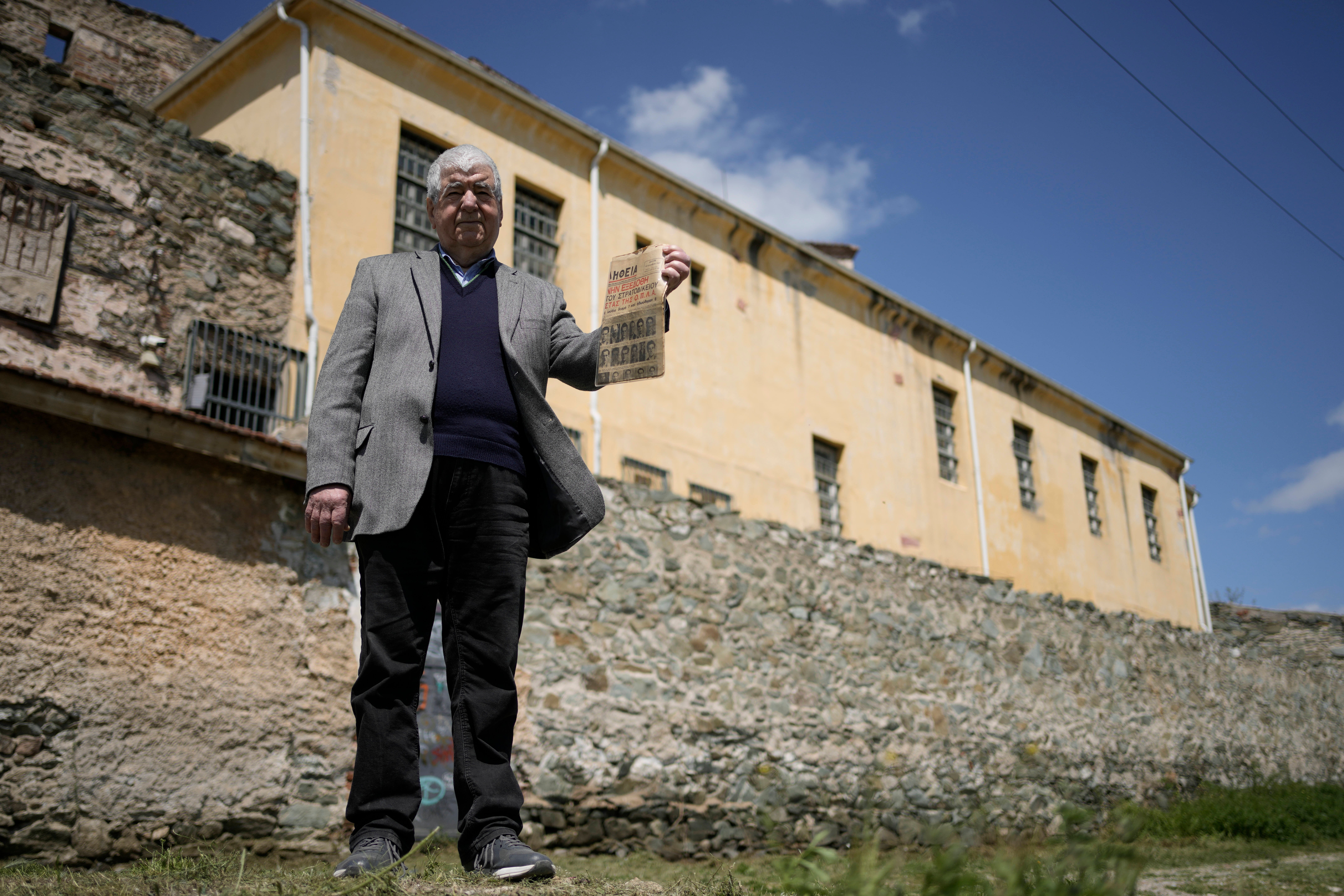 Author and historian Spyros Kouzinopoulos holds a newspaper announcing the Sept. 15, 1947, court ruling to execute 52 people being held at Yedi Kule prison, which is now a museum, in Thessaloniki, Greece, on Saturday, April 12, 2025. (AP Photo/Thanassis Stavrakis)