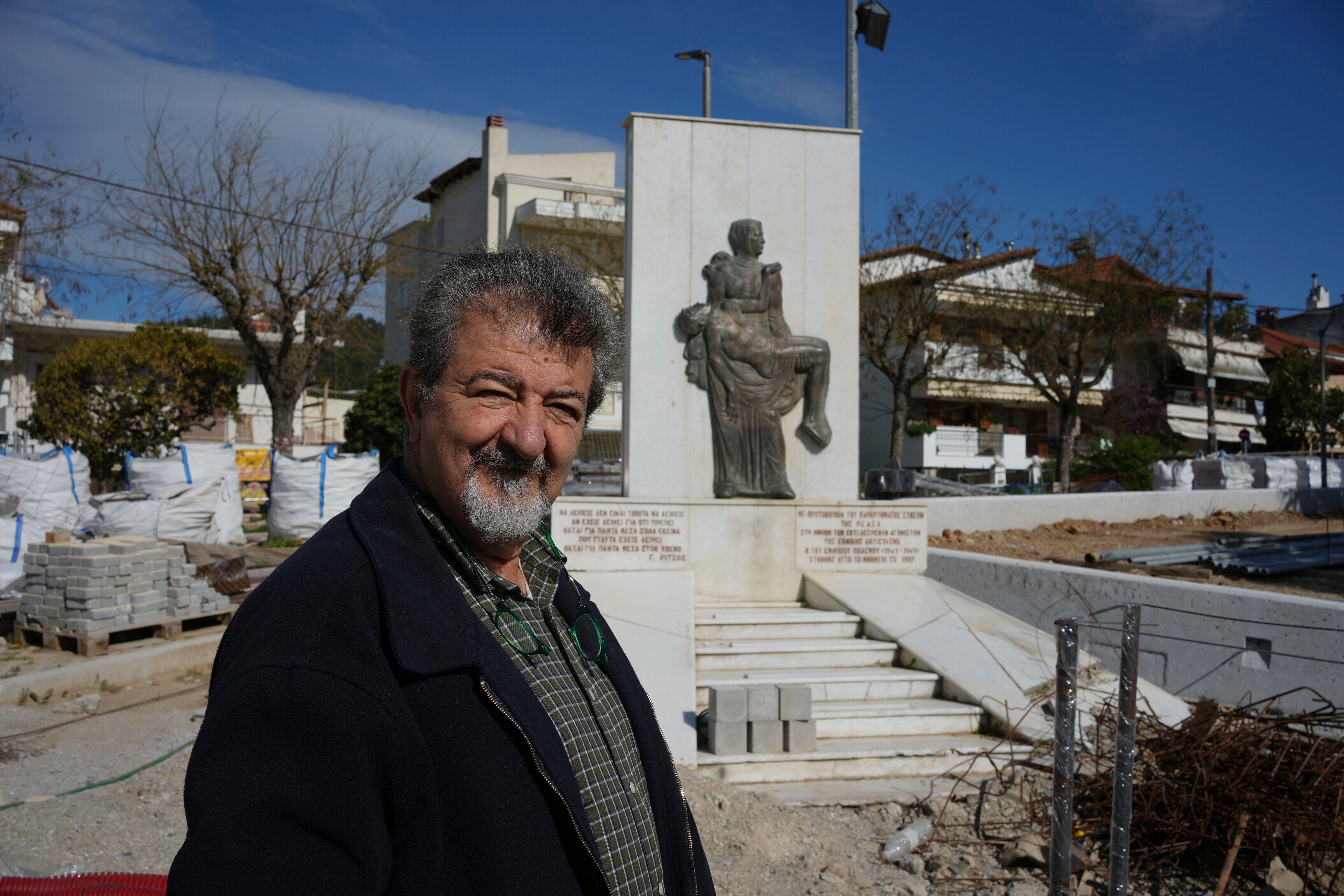 Simos Daniilidis, mayor of Neapoli-Sykies, poses in front of a monument in Thessaloniki, Greece, Friday, April 11, 2025. (AP Photo/Thanassis Stavrakis)