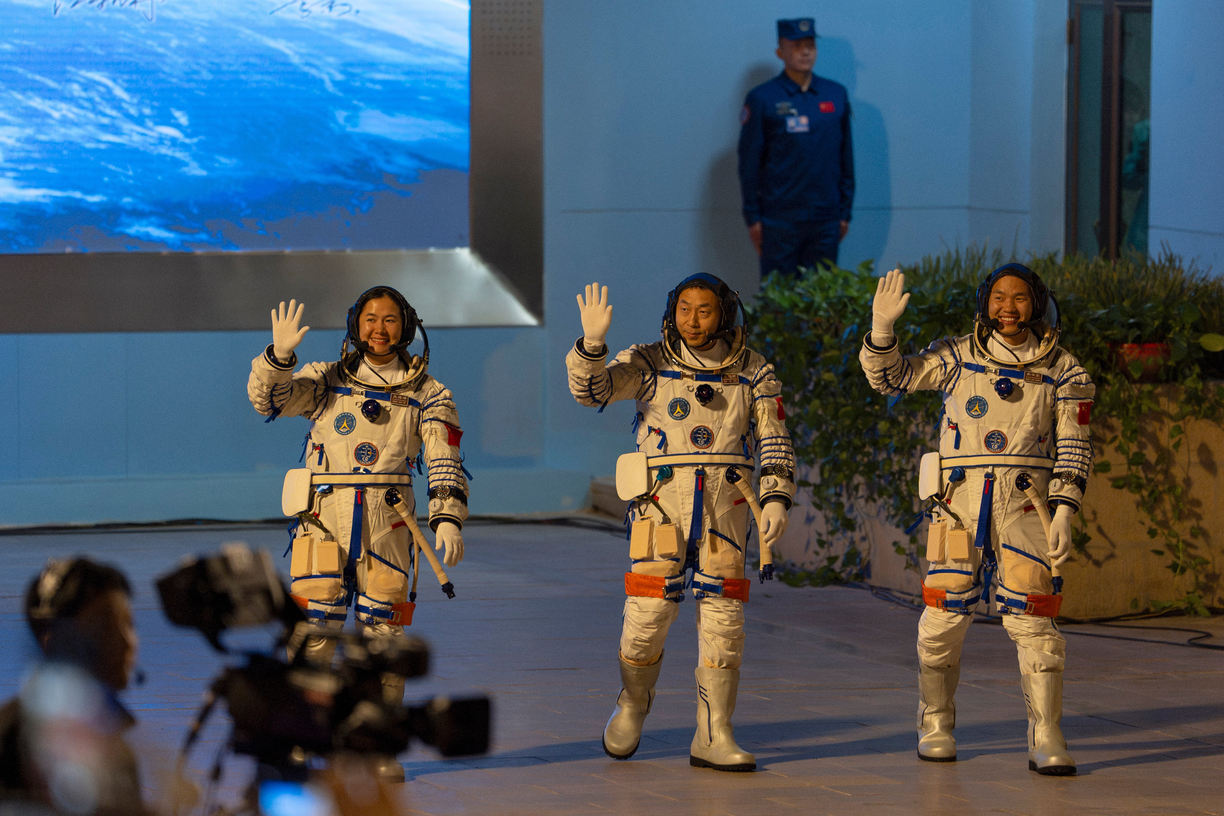 Chinese astronauts Wang Haoze, from left, Cai Xuzhe and Song Lingdong