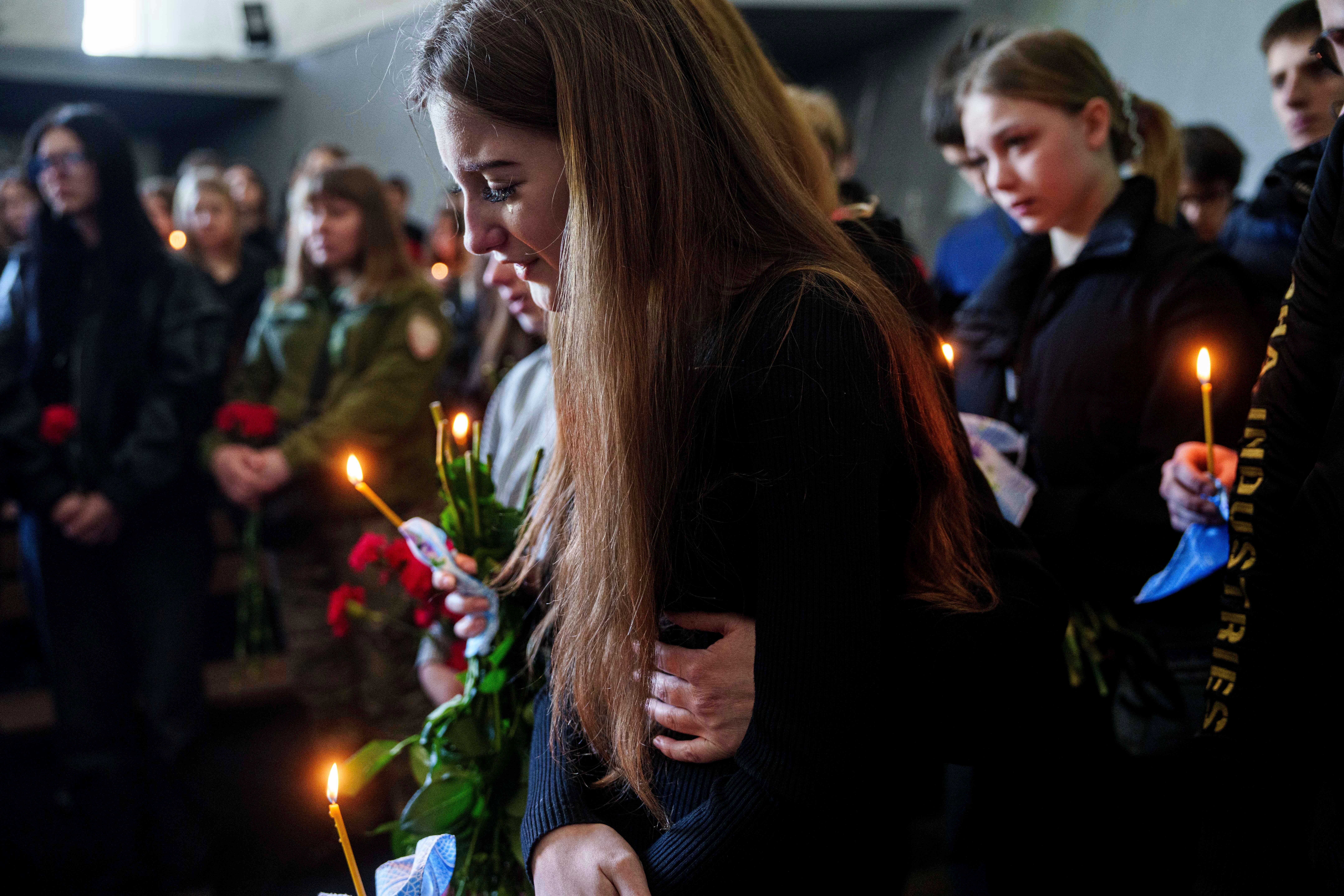Alyona Zavadska, 16, cries near the coffin of her boyfriend Danylo Khudia, 17, killed in a Russian strike along with his parents, Viktoria and Oleh Khudia on April 24, during a farewell ceremony at the crematorium in Kyiv, Ukraine, on Monday, April 28, 2025. (AP Photo/Evgeniy Maloletka, File)