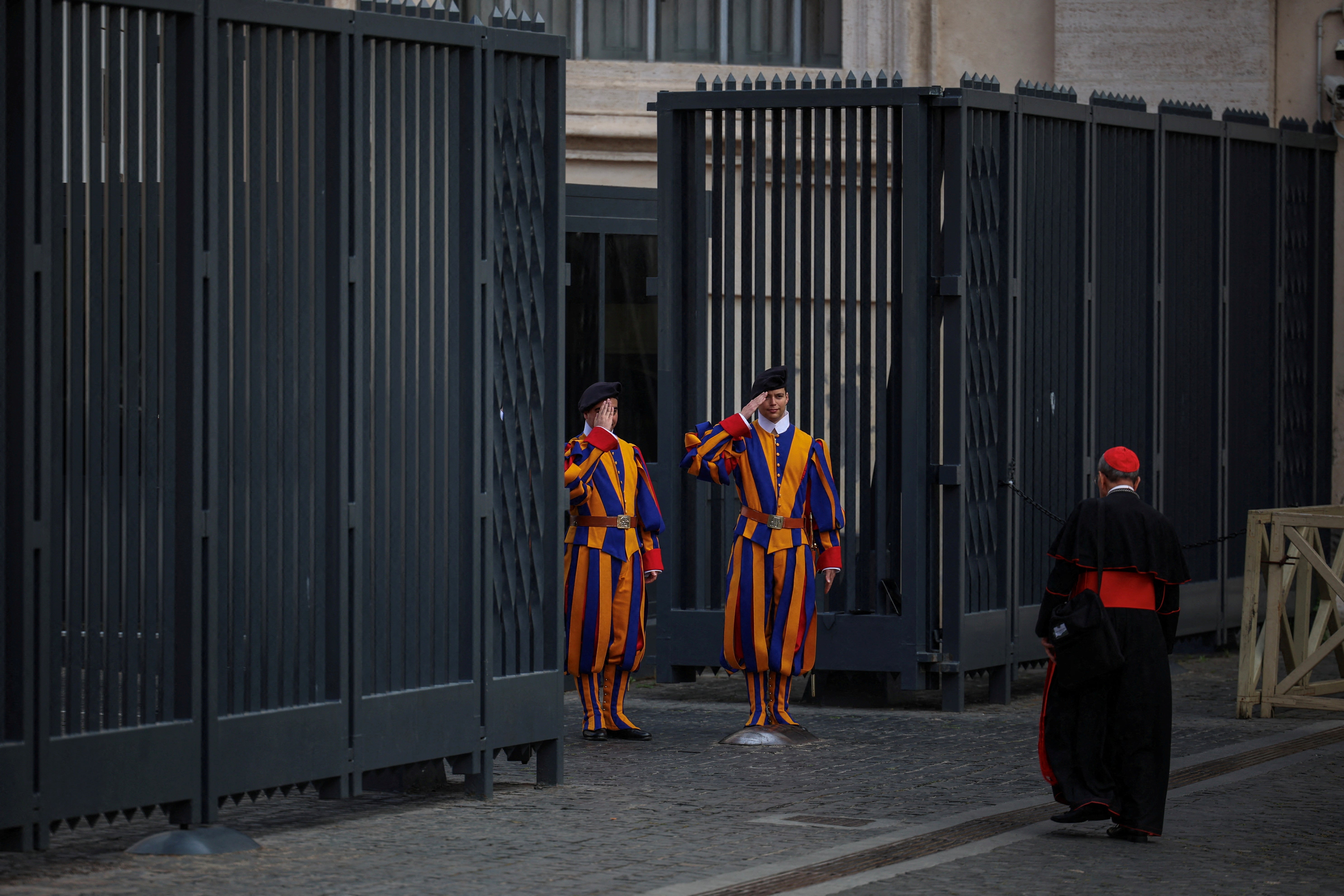 wiss Guards salute a cardinal as he arrives for a general congregation meeting in the Vatican, as seen from Rome, Italy, April 28, 2025. REUTERS/Alkis Konstantinidis/File Photo
