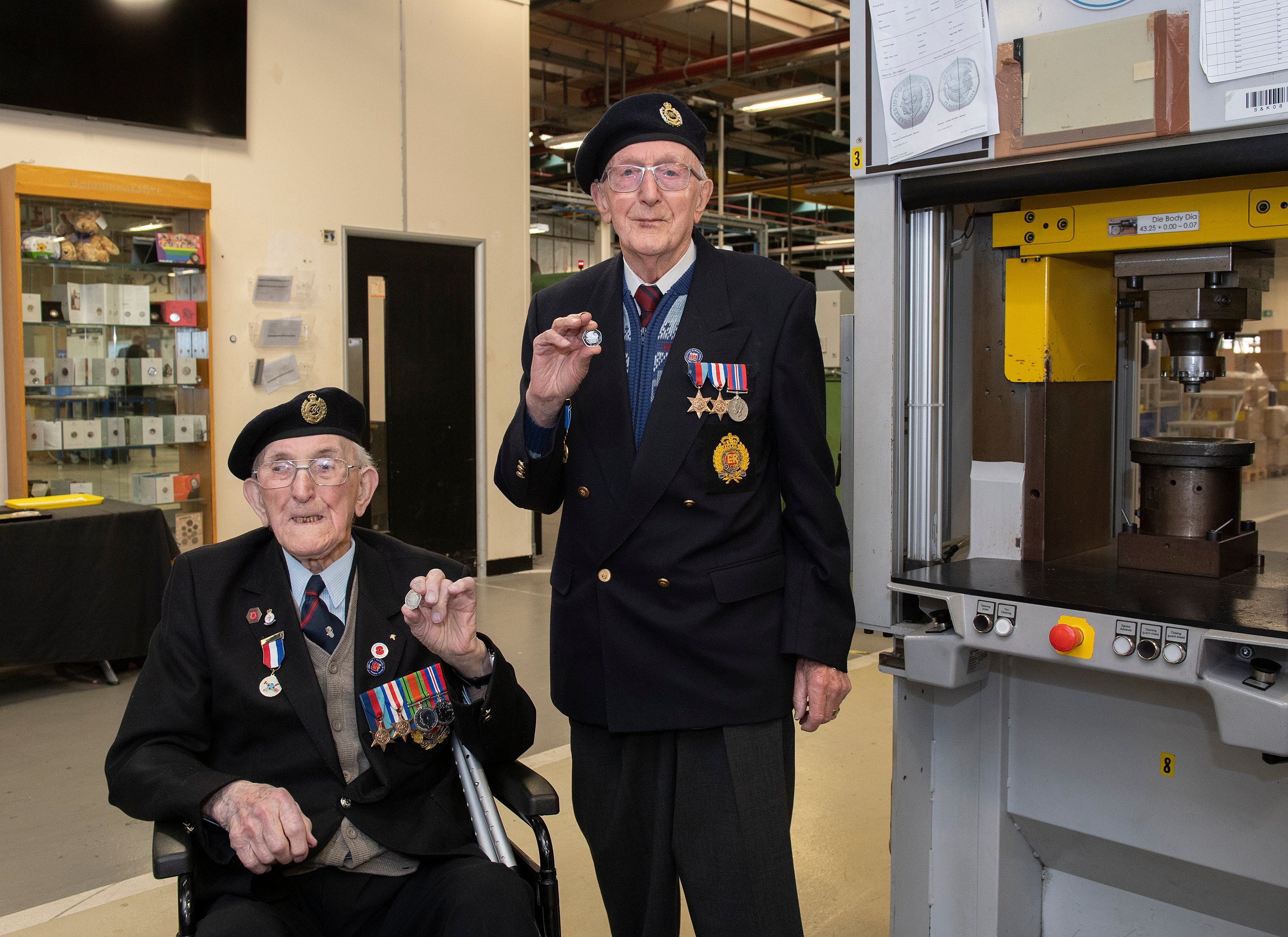 WWII veterans Richard Pelzer (left), 101, and Ron Horsey, 98, who both served with the Royal Engineers, hold the new VE Day 50p coin