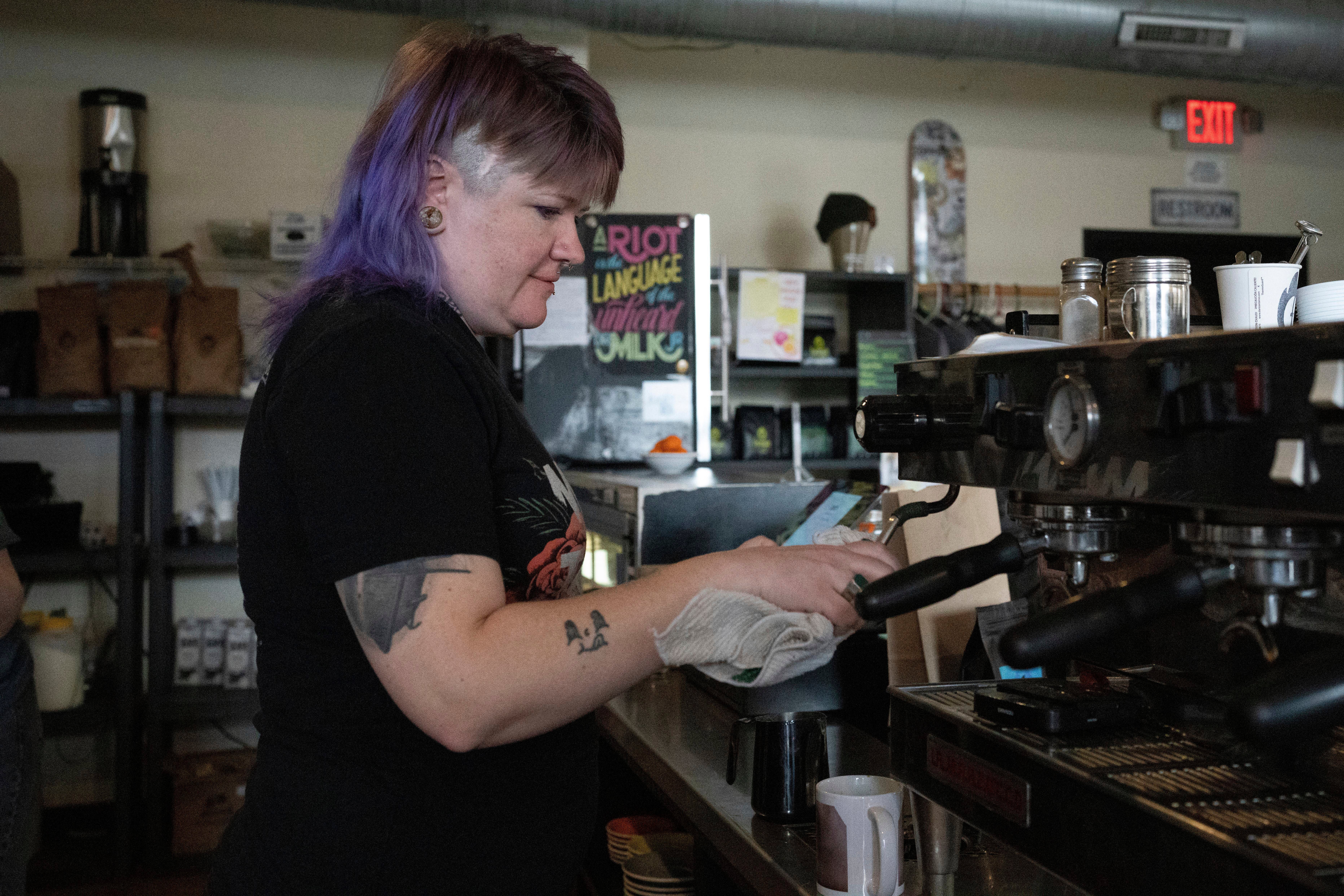Renee Colon, co-owner of Fuego Coffee Roasters, uses a coffee machine, Saturday, March 22, 2025, in Rochester, N.Y