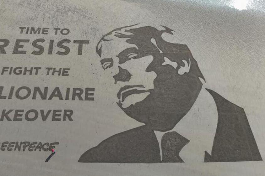 The stunt marks Donald Trump’s first 100 days in office (Greenpeace UK/PA)