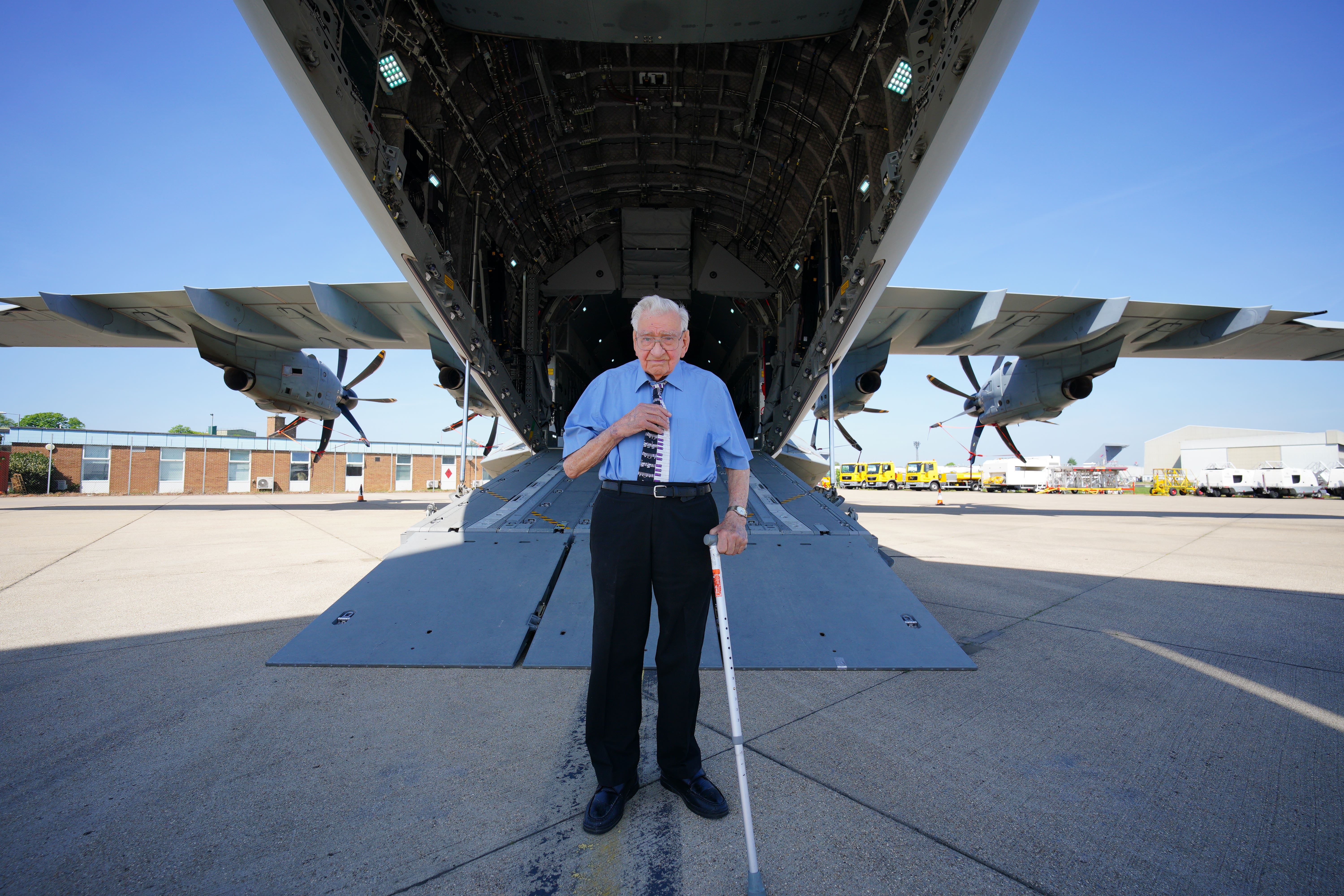 RAF veteran Dennis Bishop, who saw active service in France, Belgium, Germany and Africa, stands by the loading ramp of a Airbus A400M Atlas military transport aircraft at RAF Brize Norton, Oxfordshire (Ben Birchall/PA)