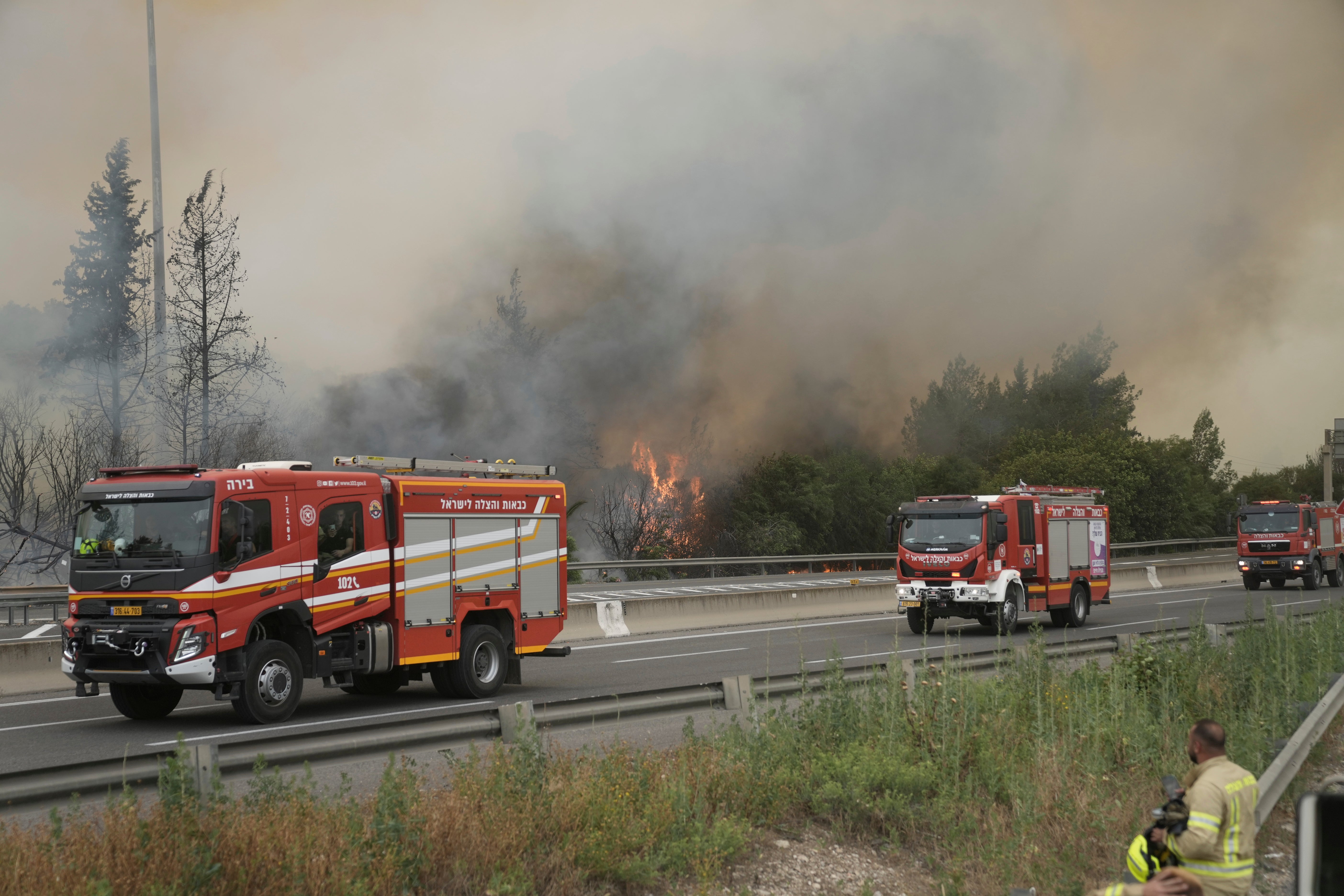Firefighters work to extinguish a forest fire burning on a freeway to Jerusalem, Wednesday, 30 April 2025