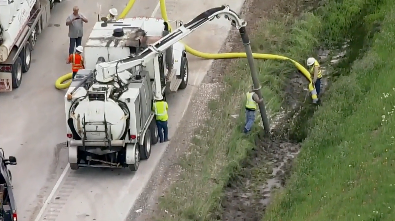 Clean-up crews attend the scene in northwest Texas, after a truck carrying $800,000 of dimes overturned, spilling eight million coins across the highway