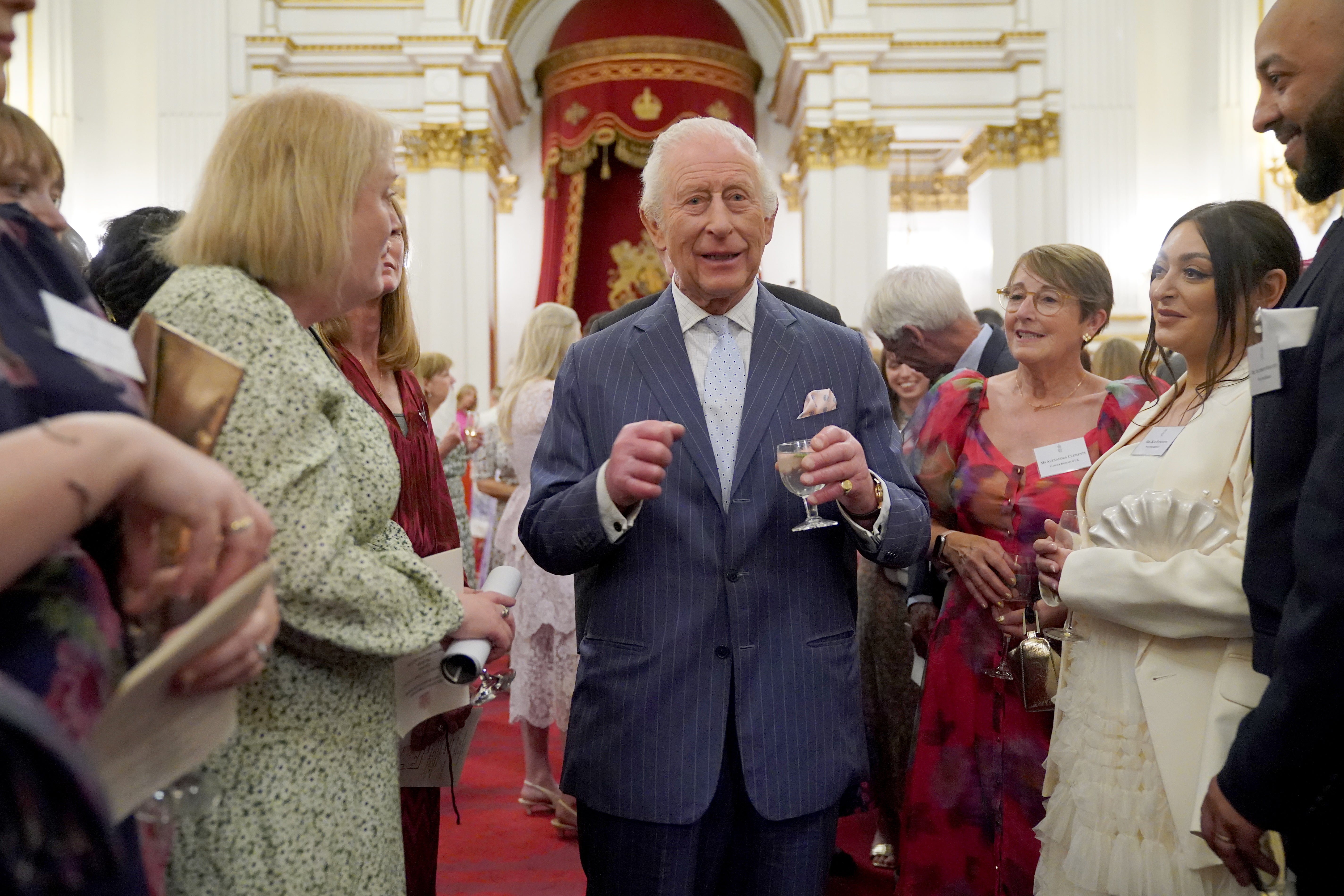 <p>King Charles speaks to guests during a reception in Buckingham Palace</p>
