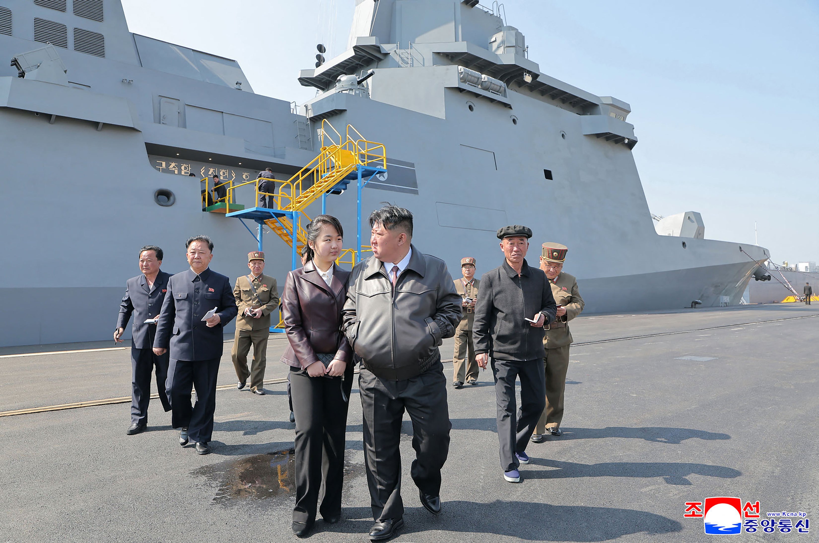 North Korea's leader Kim Jong Un and his daughter Ju Ae attend a weapons system test of naval destroyer Choe Hyon in April