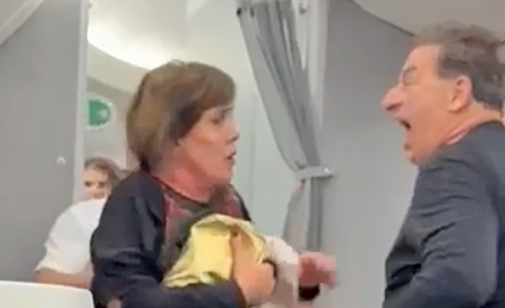 Chaos in American Airlines business class as passenger is thrown to the floor by flight attendant she then threatens to ‘kick in the balls’