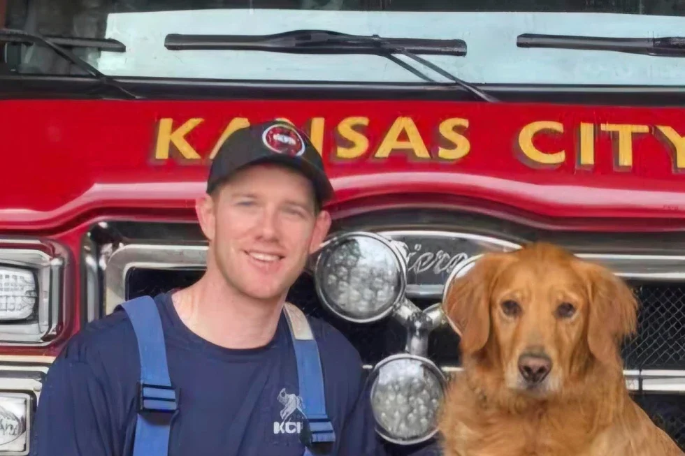 This image provided by the Kansas City Fire Department shows Graham Hoffman, a Kansas City, Mo., firefighter and paramedic, posing for a picture at a fire station after joining the department in 2022