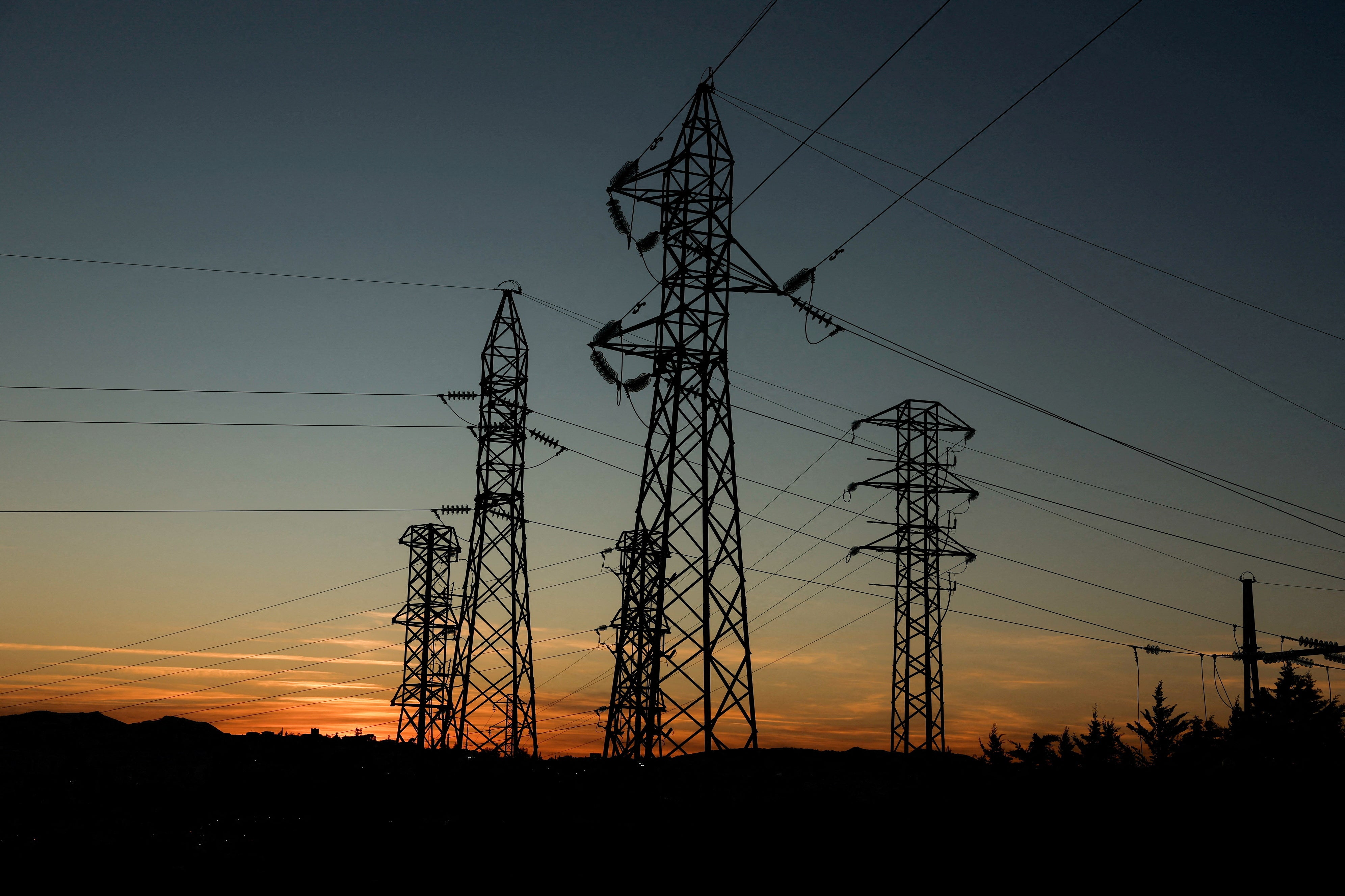 Power lines connecting pylons of high-tension electricity are seen during sunset at an electricity substation on the outskirts of Ronda, during a blackout in the city, Spain April 28, 2025. REUTERS/Jon Nazca/File Photo