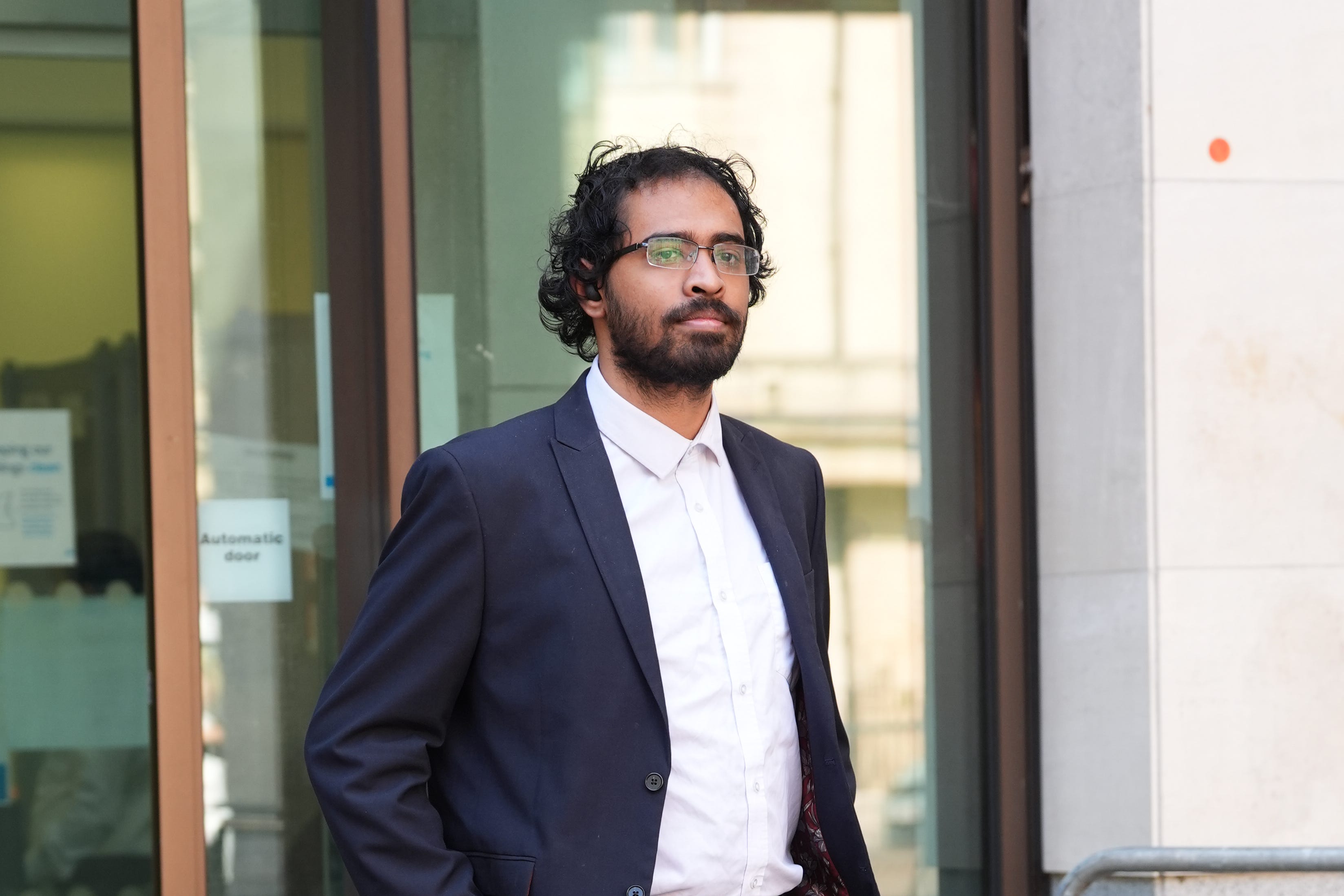 Ifthikhar Alam, 25, outside Westminster Magistrates’ Court, central London, where he is charged with three counts of fraud by false representation (Lucy North/PA).