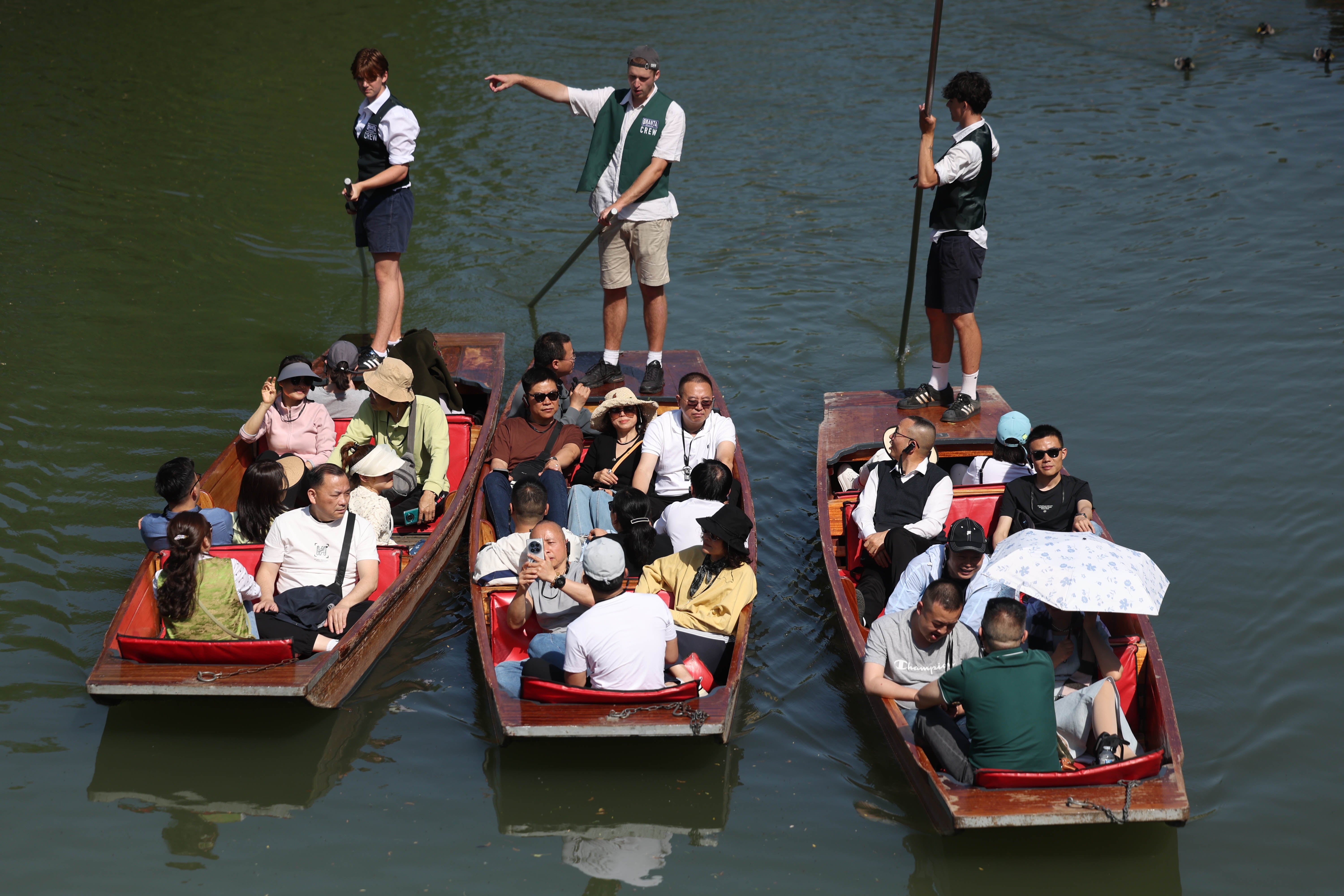 People punt on the River Cam in Cambridge on May 1