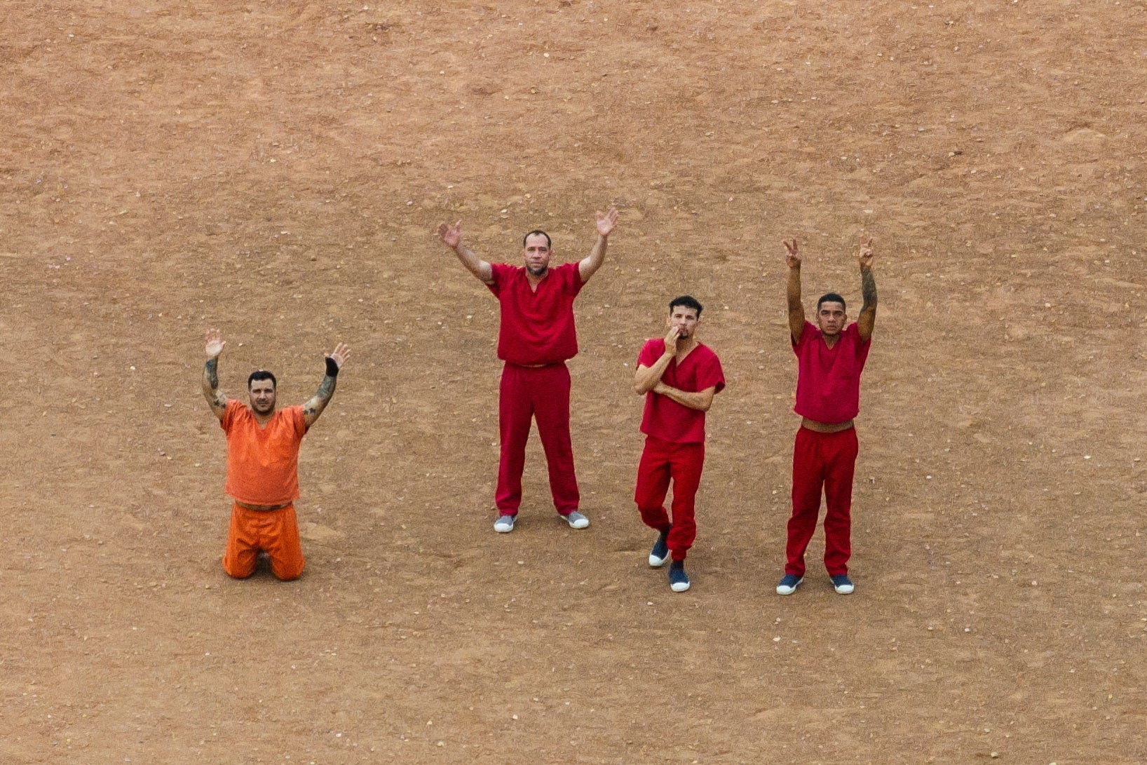 Detainees waving at the drone flying over the courtyard