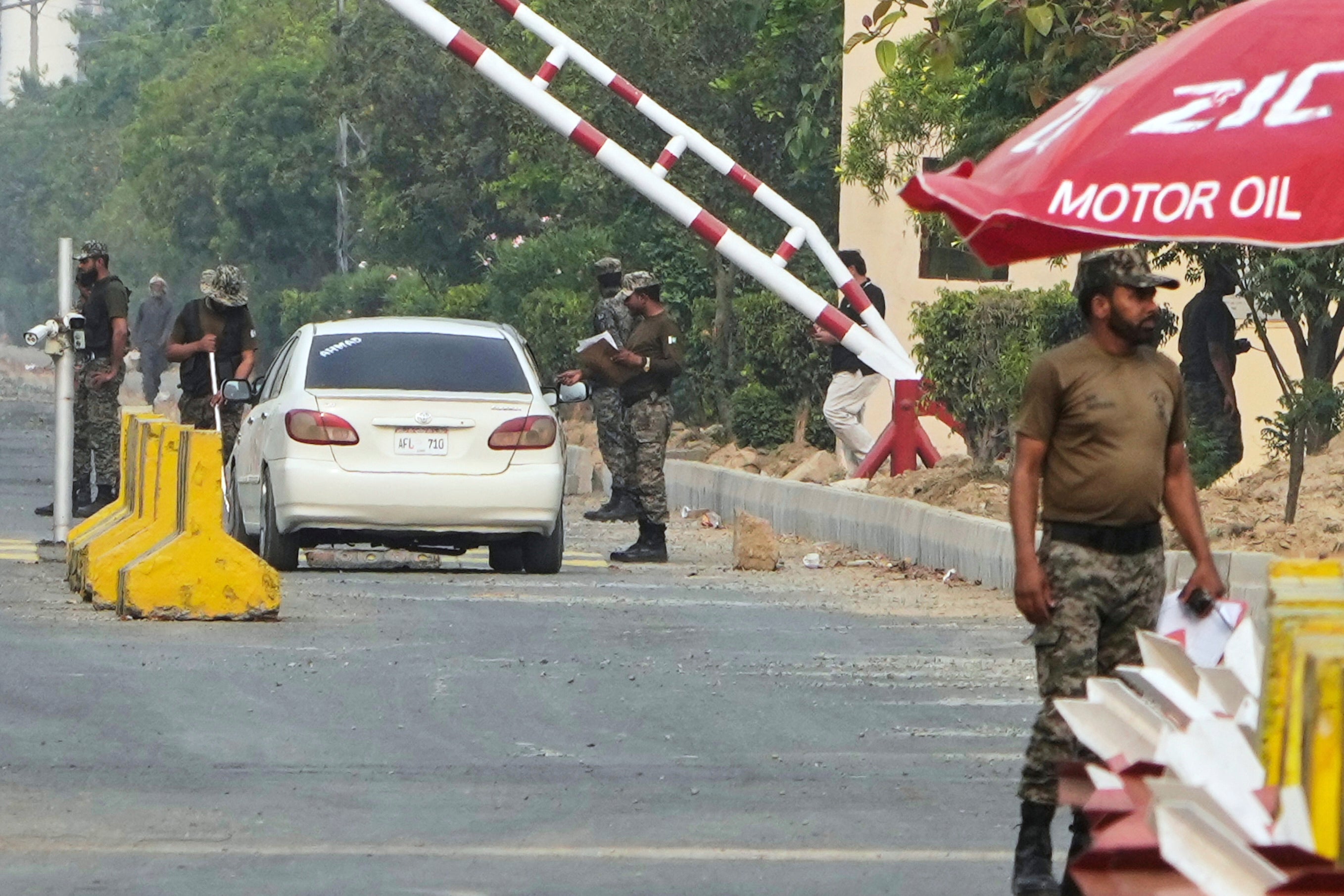 Paramilitary soldiers frisk a car at a checkpoint at Wagah, a joint border crossing point on the Pakistan and India border, near Lahore, Pakistan, Thursday, May 1, 2025.(AP Photo/K.M. Chaudary)