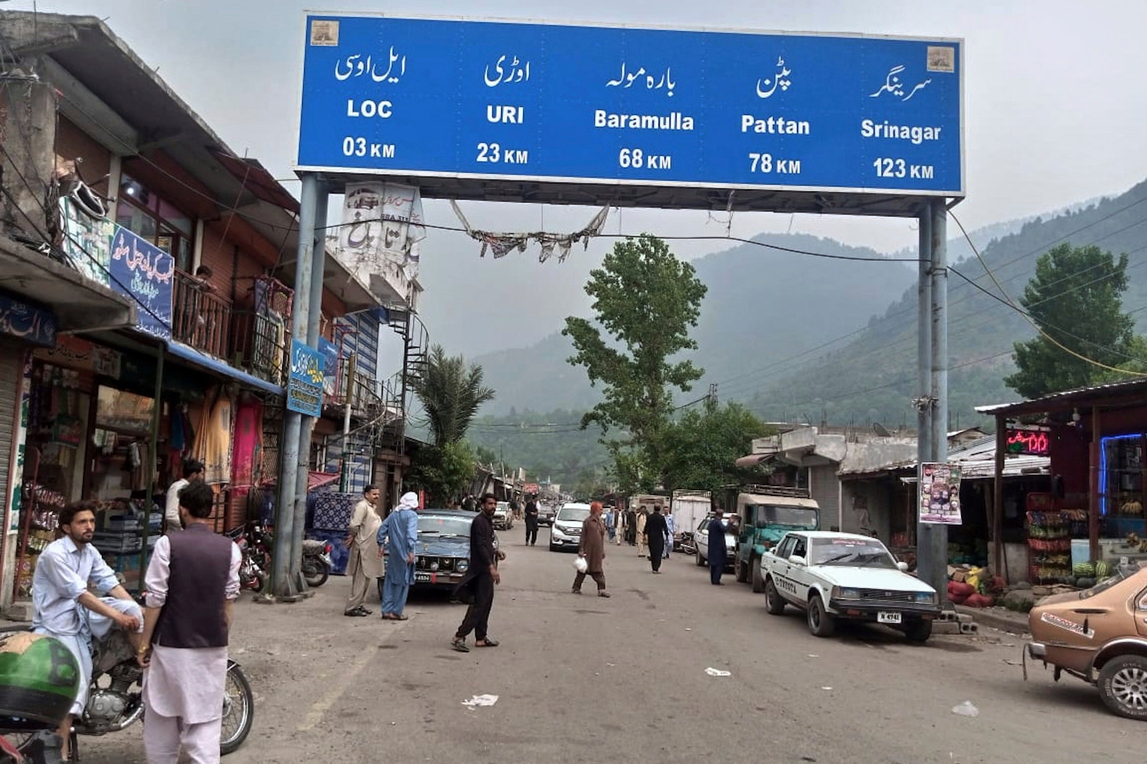 Local residents walk through the main bazaar of Chakothi, near Line of Control, the de facto border dividing Pakistan and Indian Kashmir, some 61 kilometers (38 miles) from Muzaffarabad