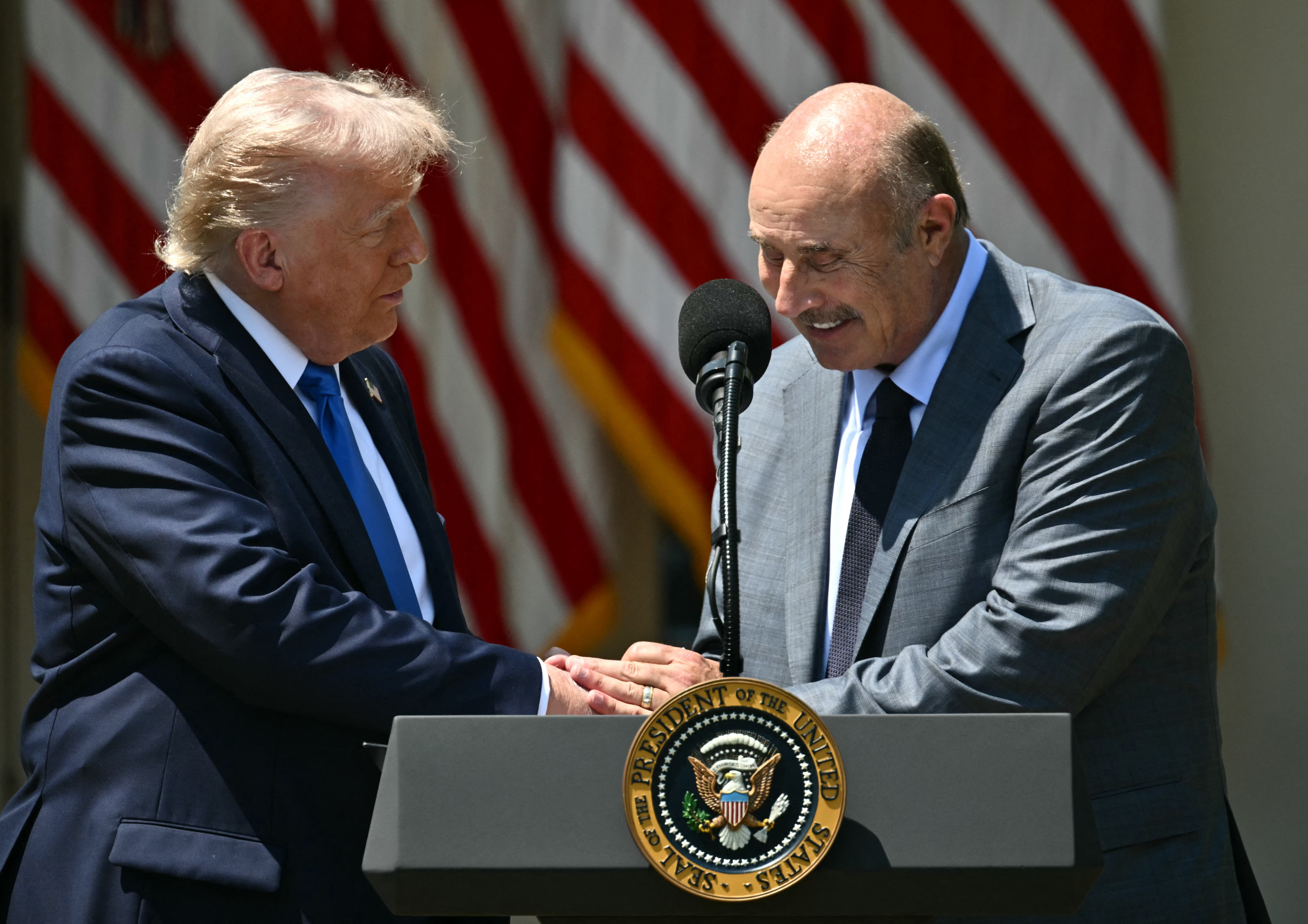The president welcomed Dr. Phil to join him on the stage, where the TV star said he was ‘proud’ to see ‘religion come back to the White House’