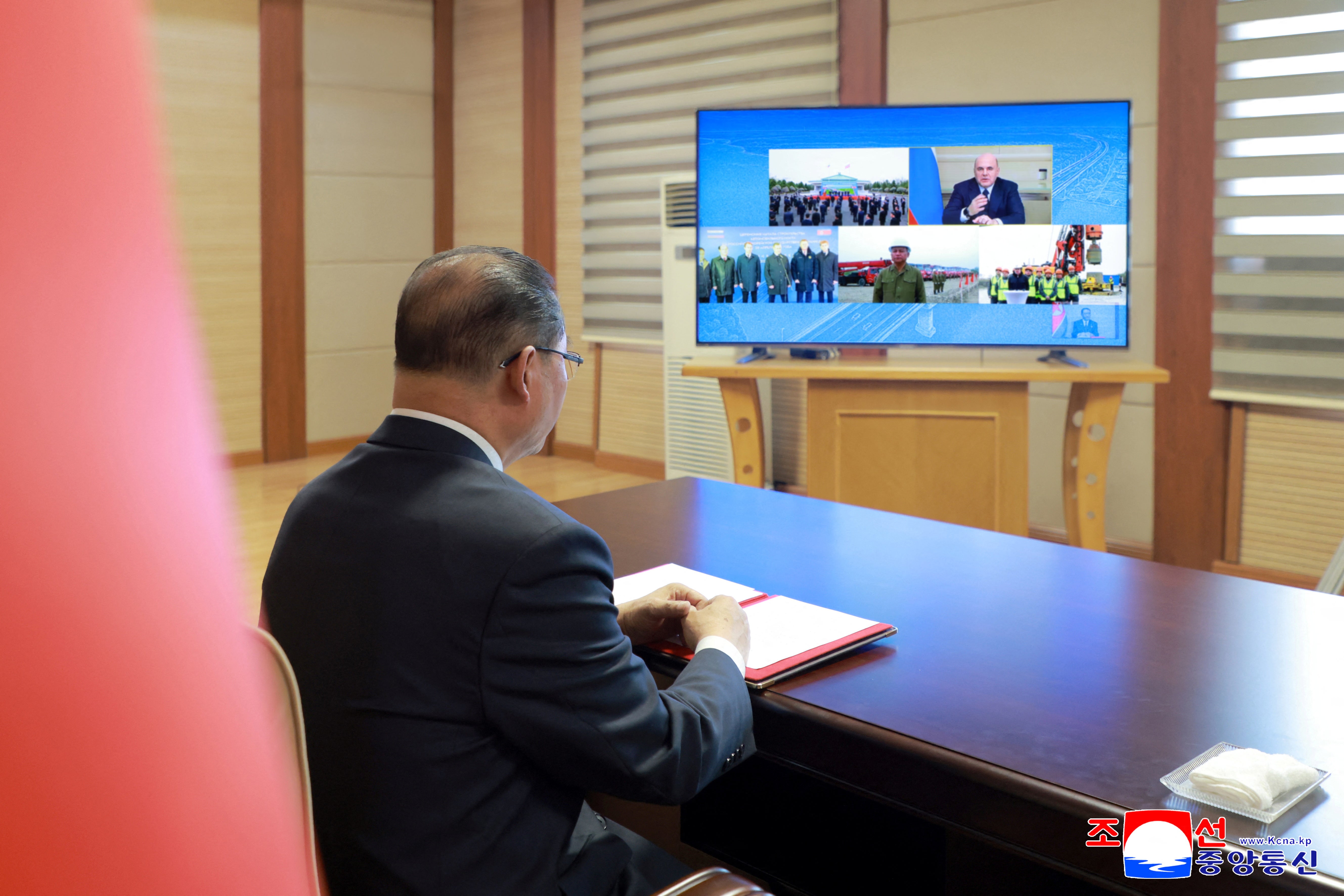 North Korea's premier Pak Thae Song joins Russian prime minister Mikhail Mishustin via video-conferencing to attend a ground-breaking ceremony for a new road bridge spanning the Tumen River that will link North Korea to Russia, in Pyongyang,