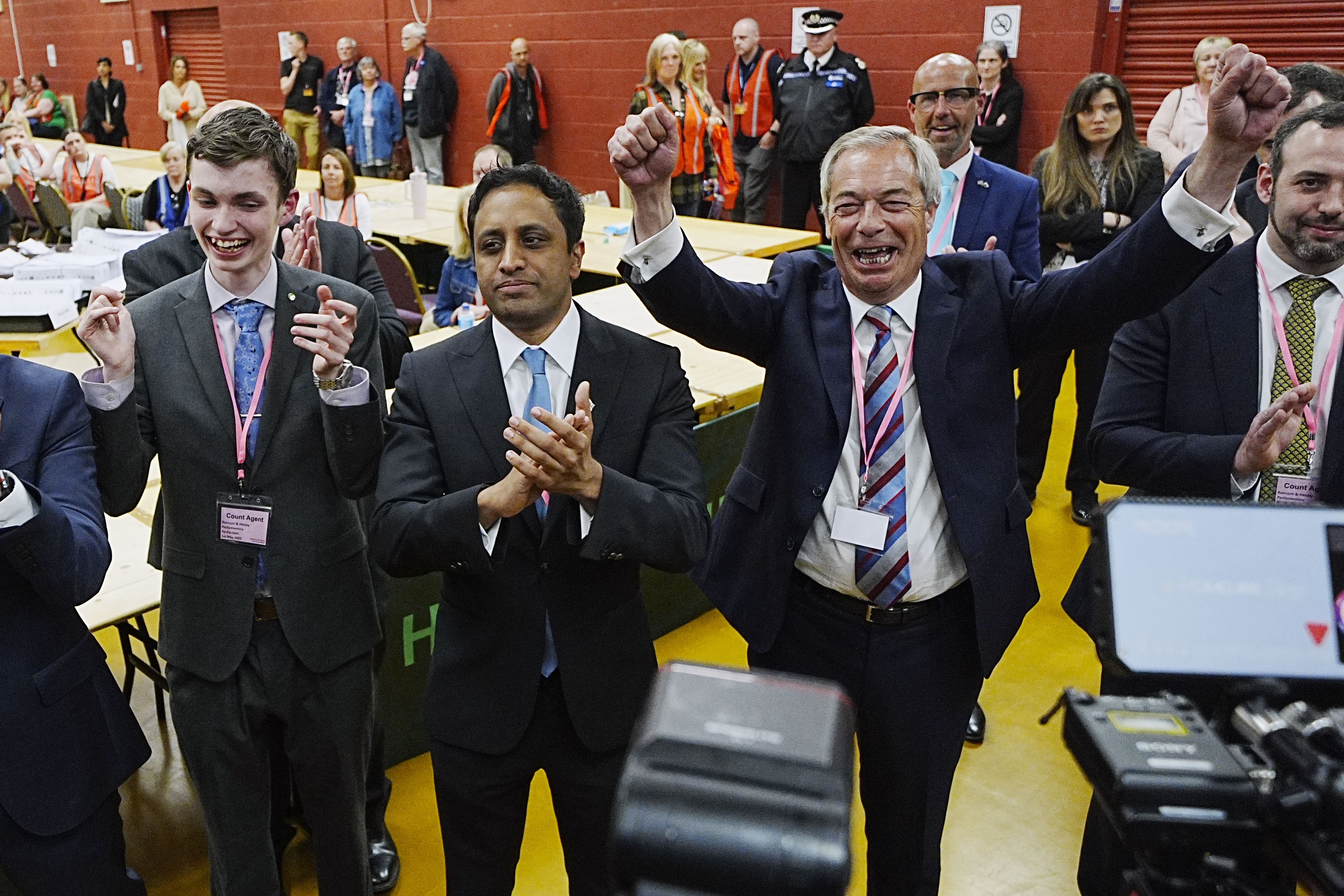 Reform UK leader Nigel Farage (right) and chairman Zia Yusuf (centre) celebrate after Reform candidate Sarah Pochin won the Runcorn and Helsby by-election (Peter Byrne/PA)