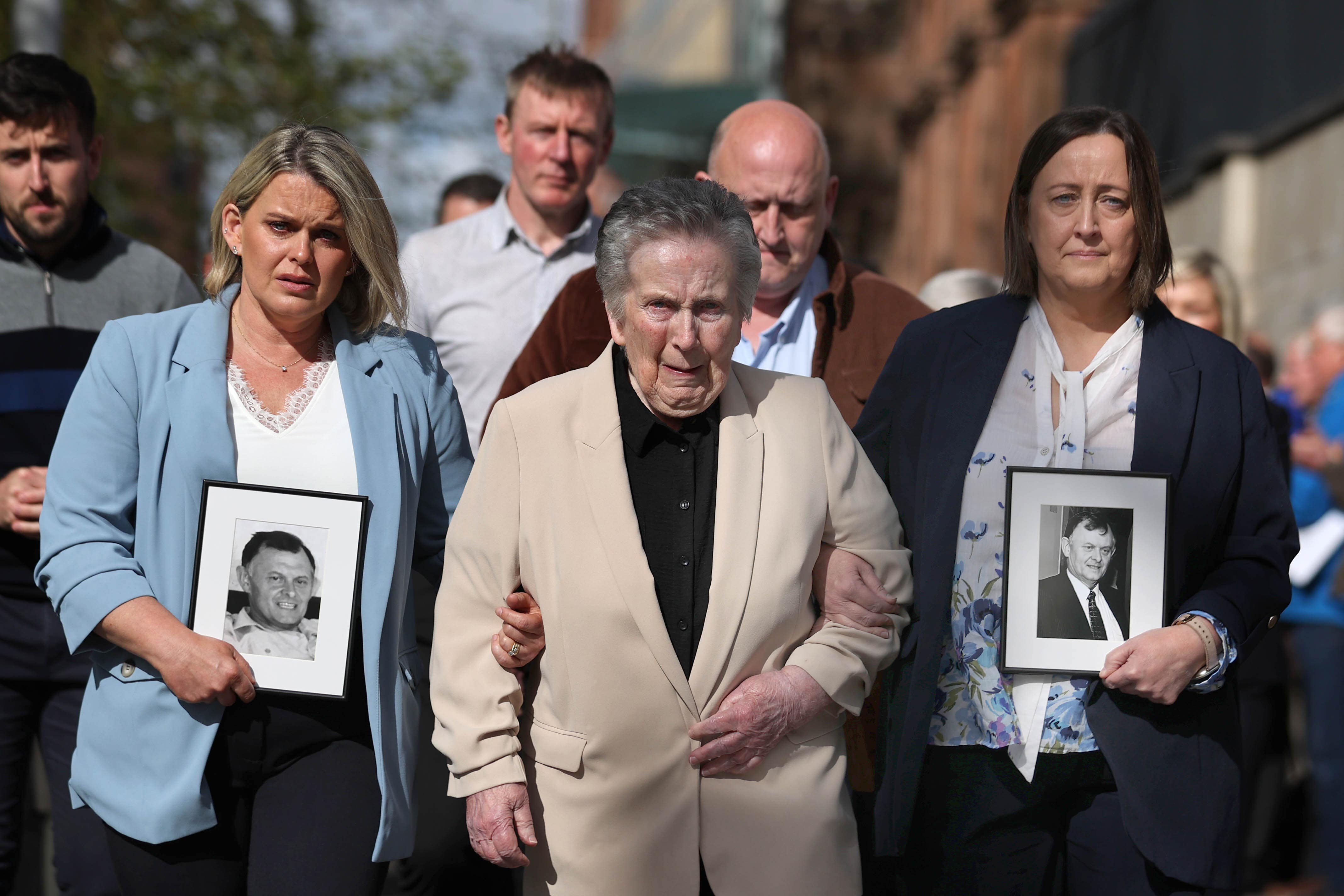 Supporters of the family of GAA official Sean Brown, with widow Bridie Brown (centre), daughter Siobhan Brown (right), daughter Clare Loughran (left) arrive at Belfast’s Court of Appeal (Liam McBurney/PA)