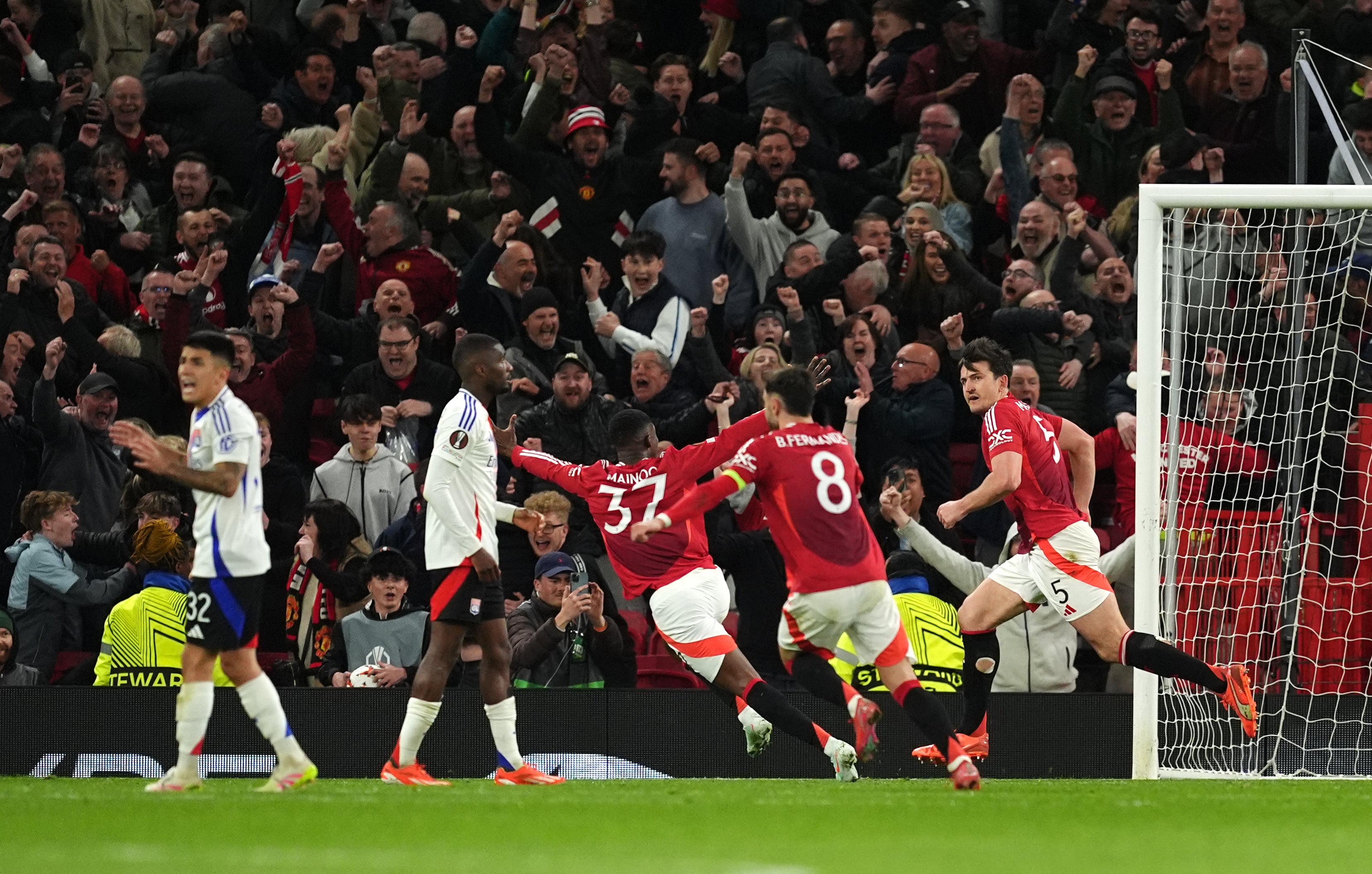 Harry Maguire (right) sparked bedlam with his extra-time winner against Lyon in the quarter-finals