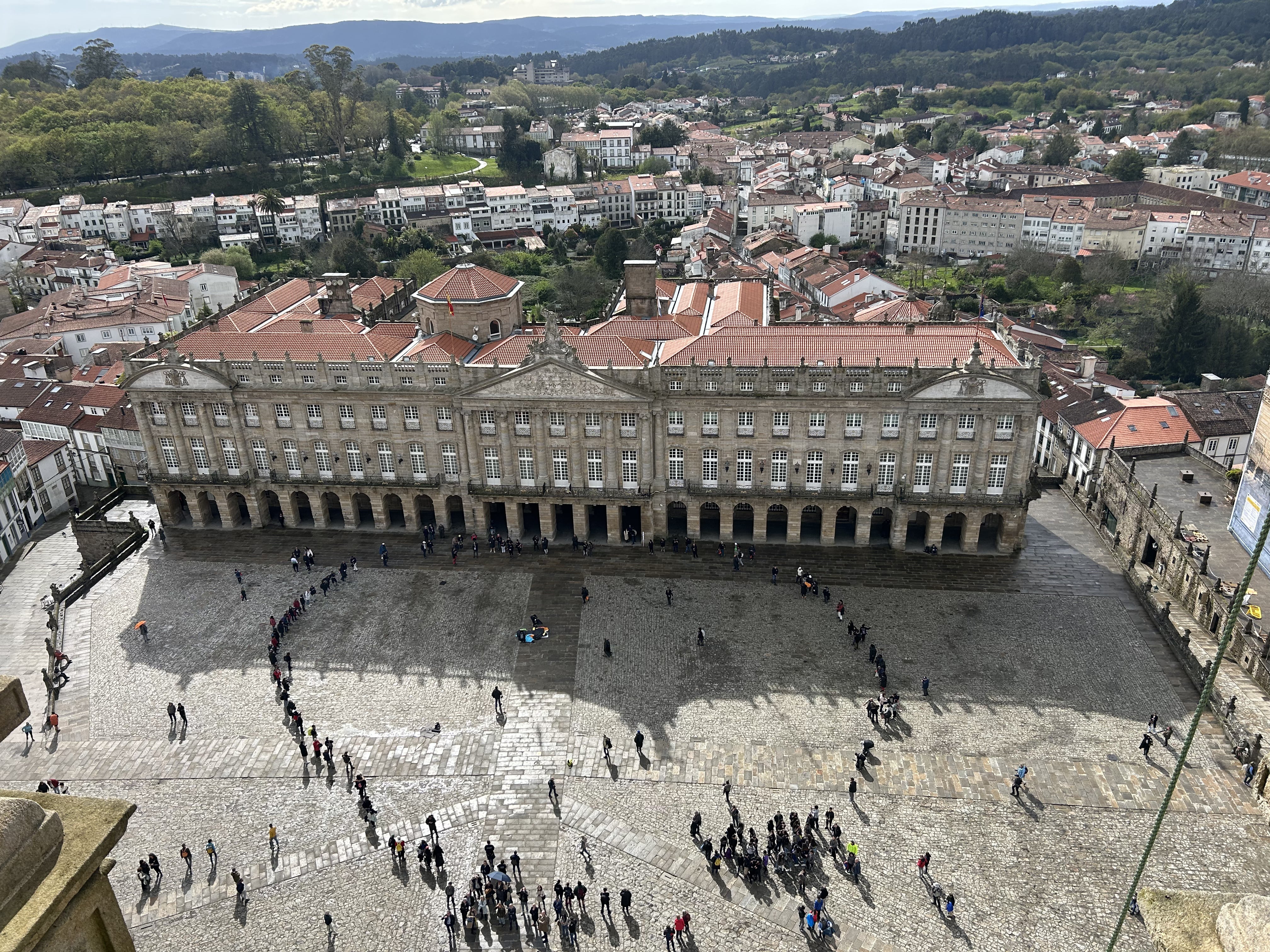 Pilgrims joining hands in the Praza do Obradoiro square