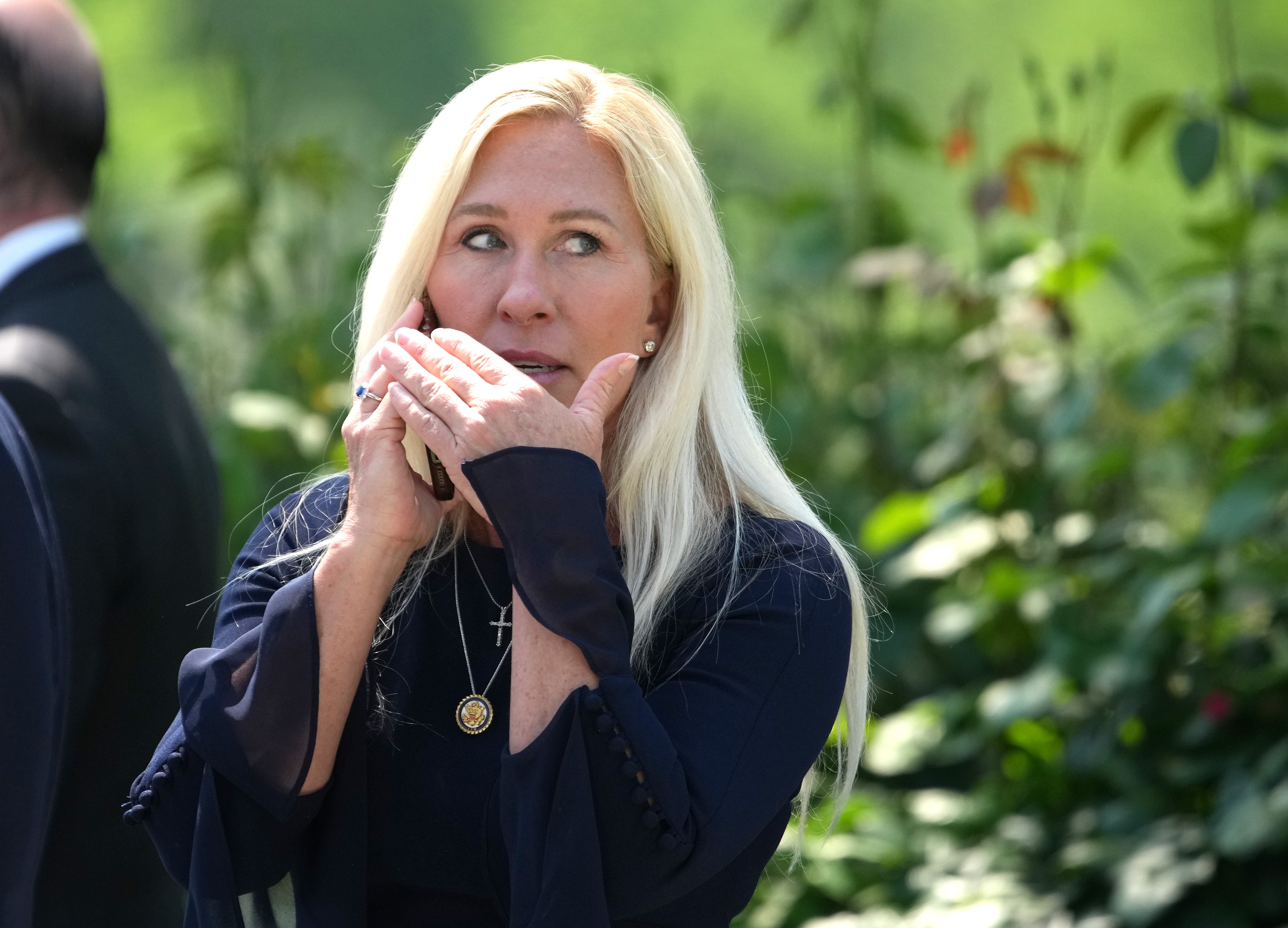 U.S. Rep. Marjorie Taylor Greene (R-GA) talks on the phone during a National Day of Prayer event hosted by President Donald Trump in the Rose Garden at the White House on May 1, 2025 in Washington, DC
