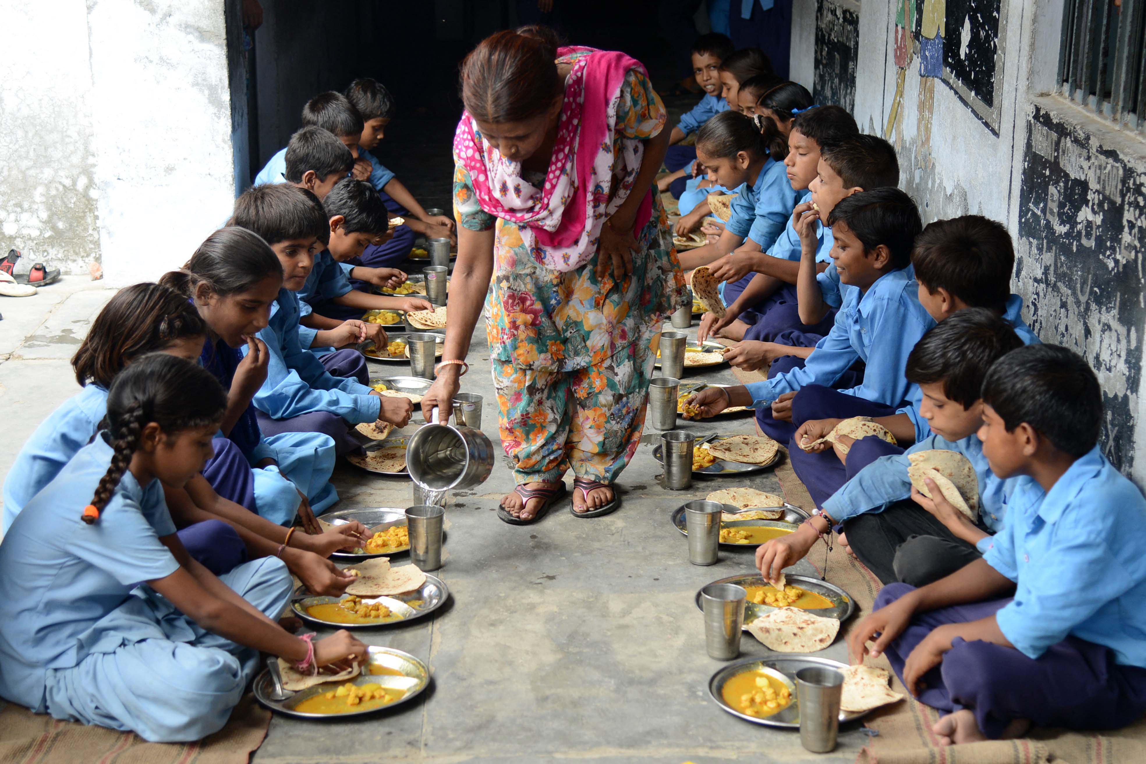Indian schoolchildren eat their free midday meal at a government school in Amritsar in 2013