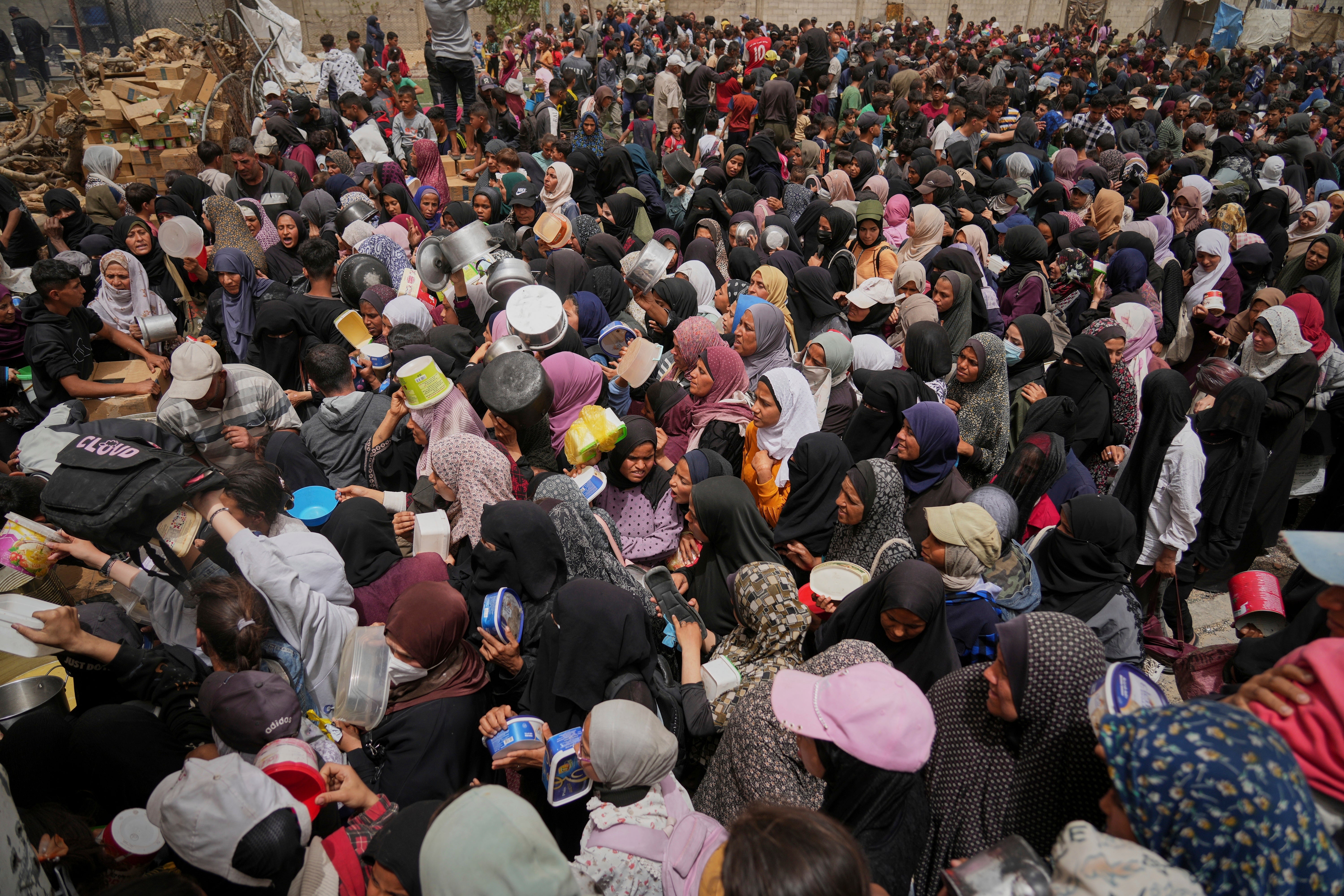 Palestinians struggle in a crowd as they try to receive donated food at a distribution centre in Nuseirat, central Gaza Strip in April 2025