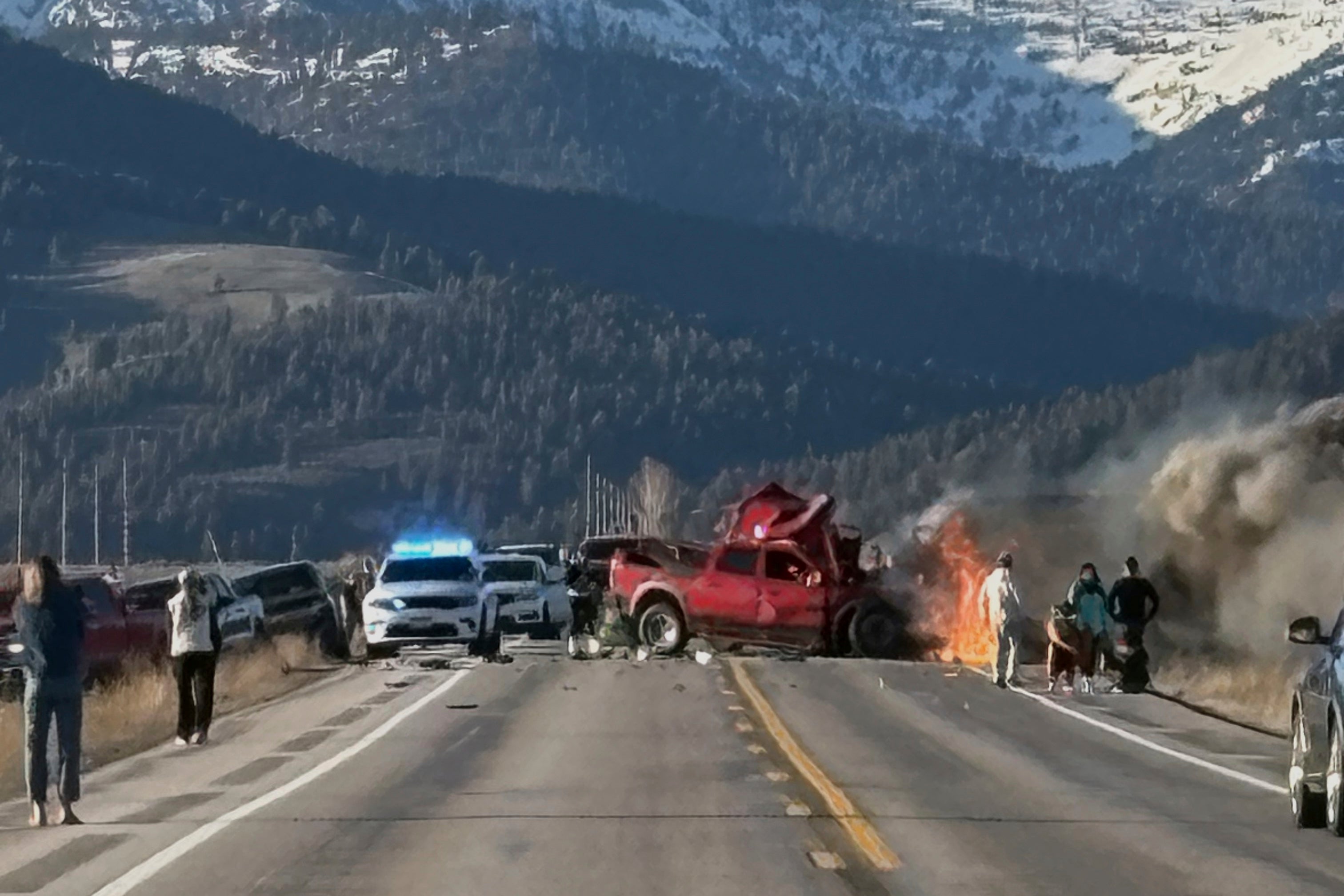 Rescue workers at the scene after a deadly collision between a pickup truck and tour van near Henry’s Lake State Park in eastern Idaho on Thursday, May 1
