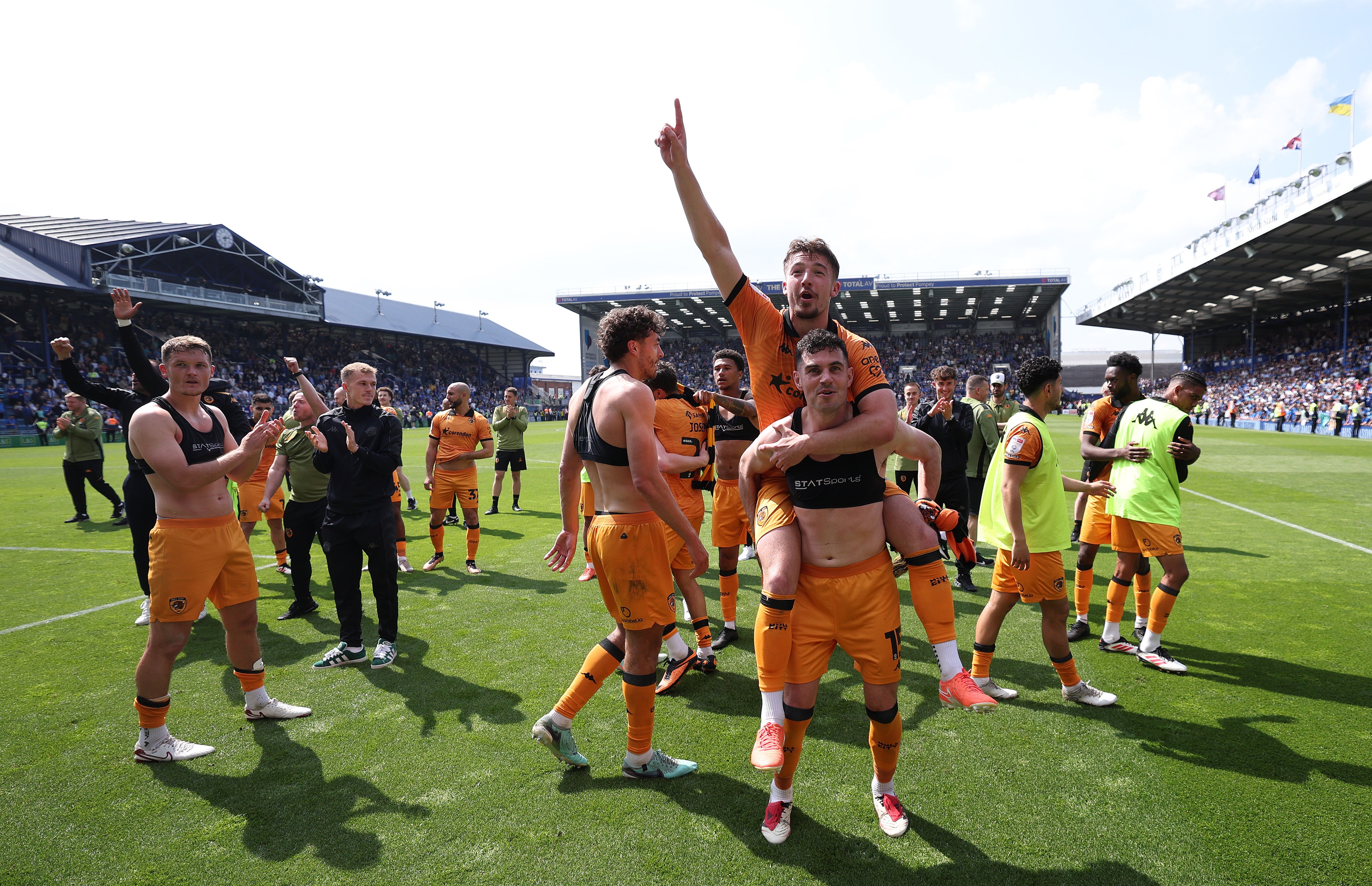 Hull City players celebrate after staying in the Championship