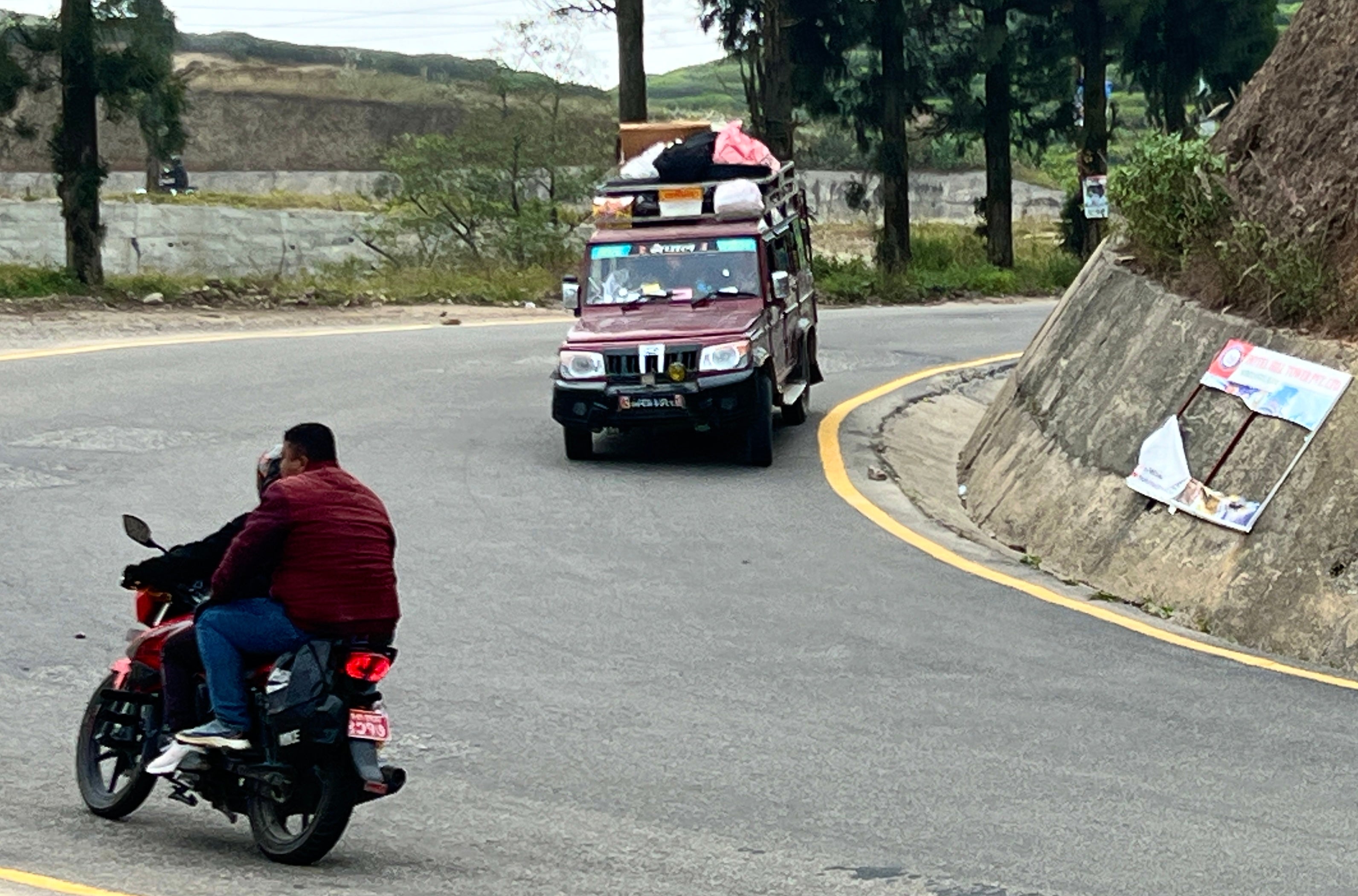 Danger zone: Motorcyclists and 4x4 on a bend in Nepal