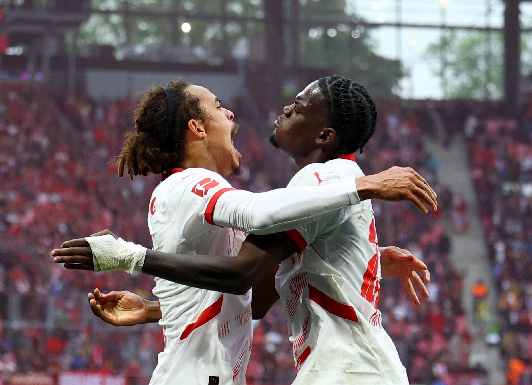 RB Leipzig’s Yussuf Poulsen celebrates scoring their third goal with Castello Lukeba