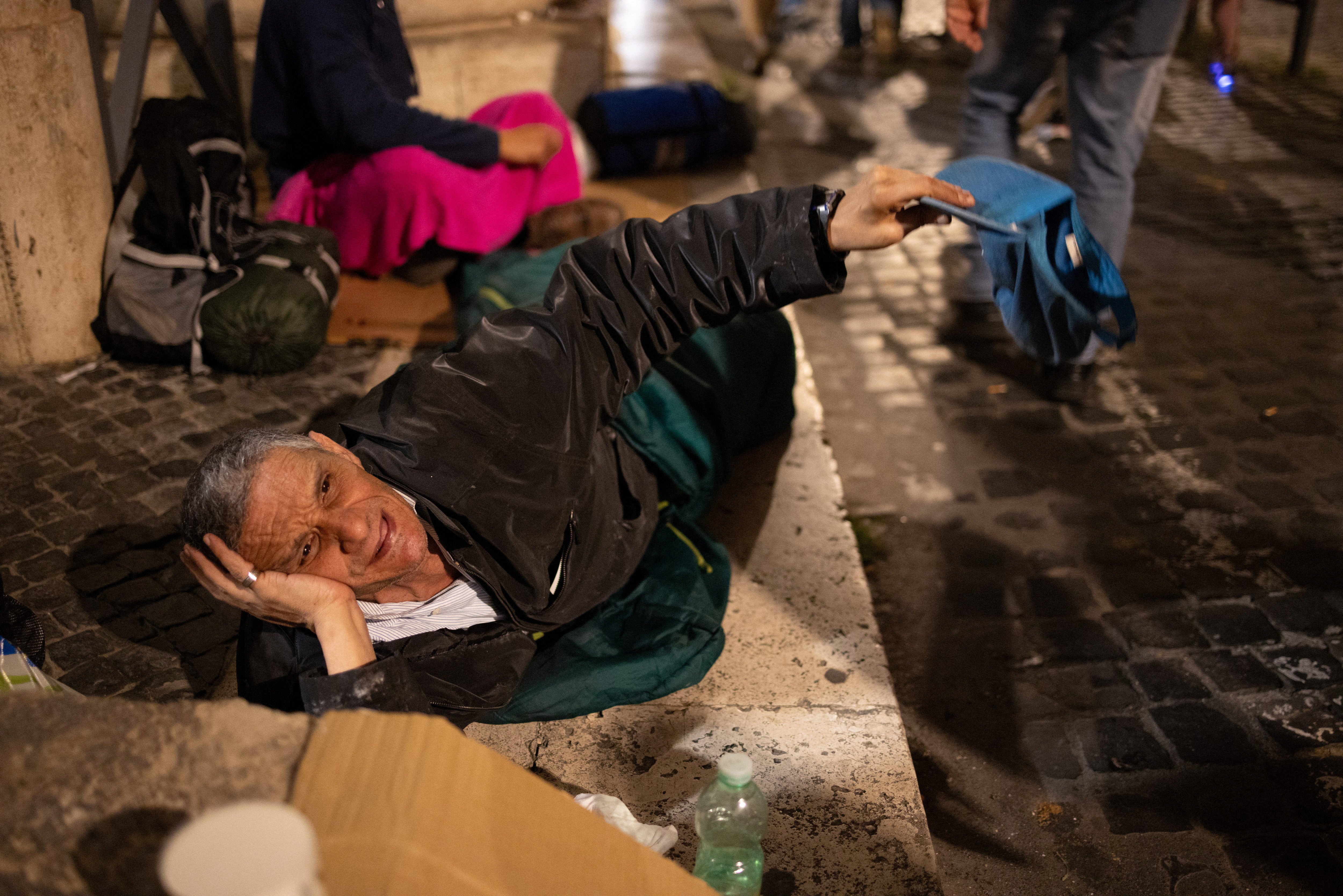 Savile Piro, who is homeless and sleeps on the streets, asks for money outside St. Peter's Basilica at the Vatican, April 24, 2025