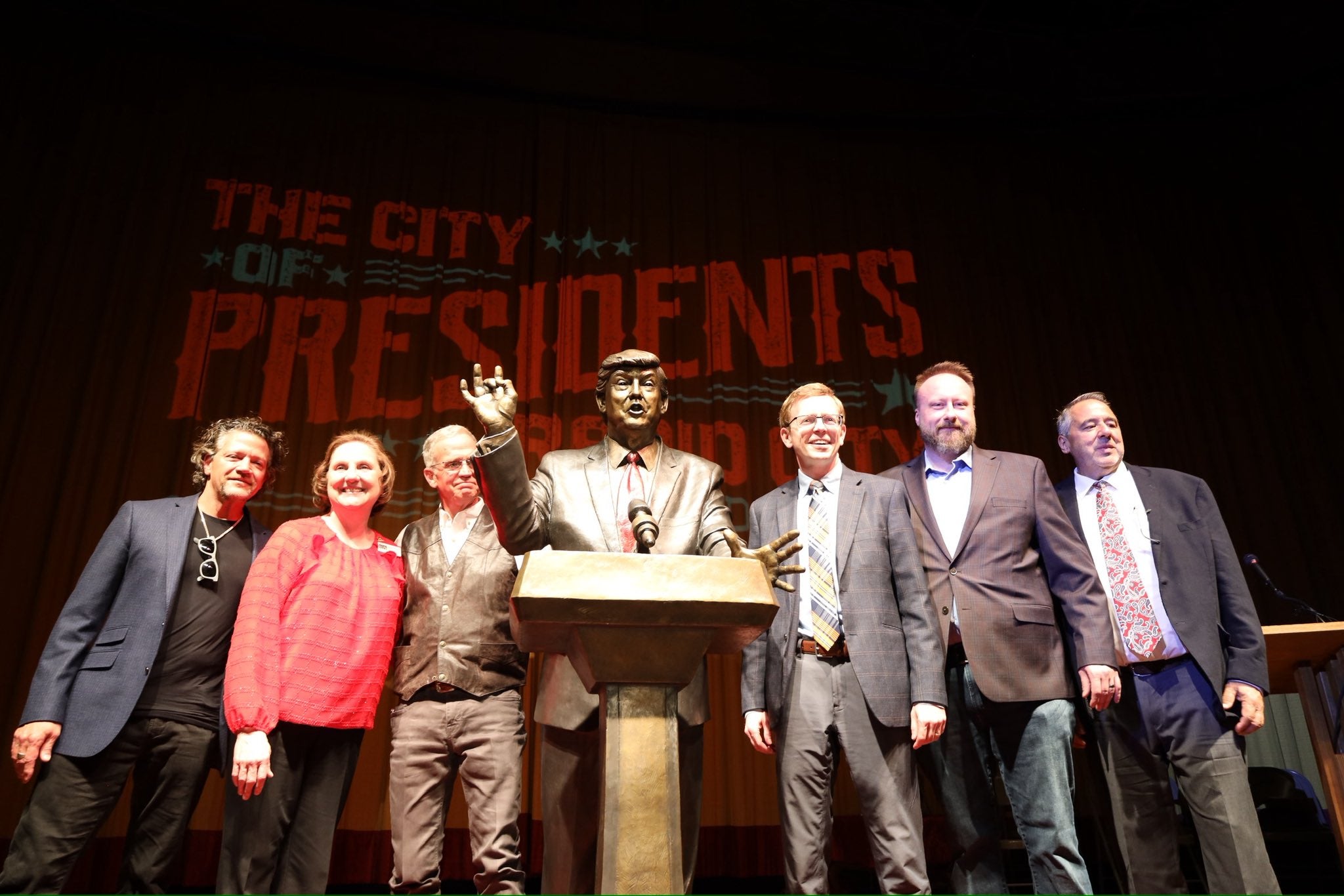 Rep Duty Johnson (center right) and other Rapid City town officials at the unveiling of a statue of Donald Trump