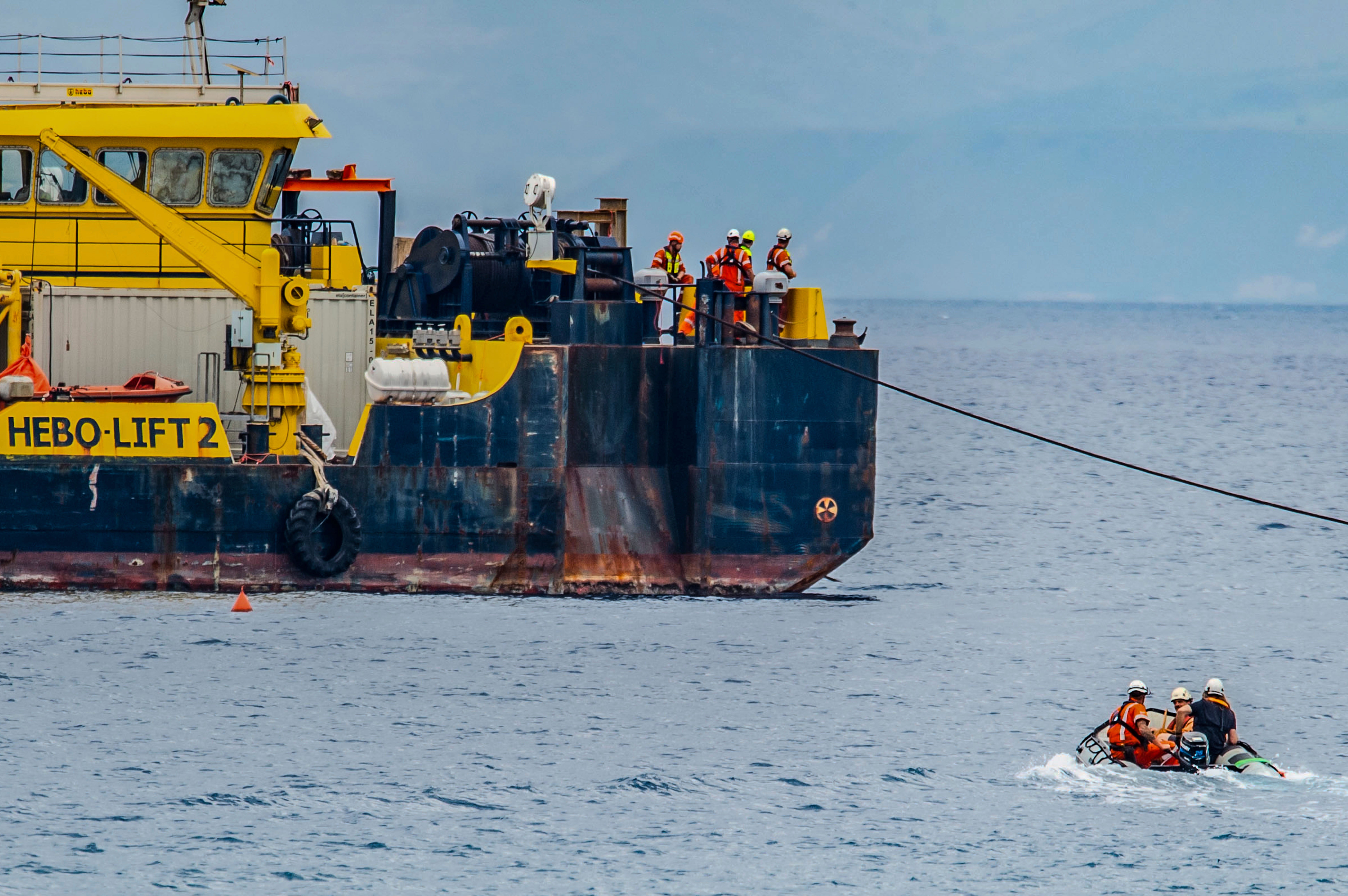 The multi-purpose floating work barge Hebo Lift 2 monitors the stretch of sea off Porticello, near Palermo, Sicily, Italy, Sunday, May 4, 2025, where the British superyacht Bayesian sunk on August 19, 2024 as the operations for its recovery start. (AP Photo/Salvatore Cavalli)