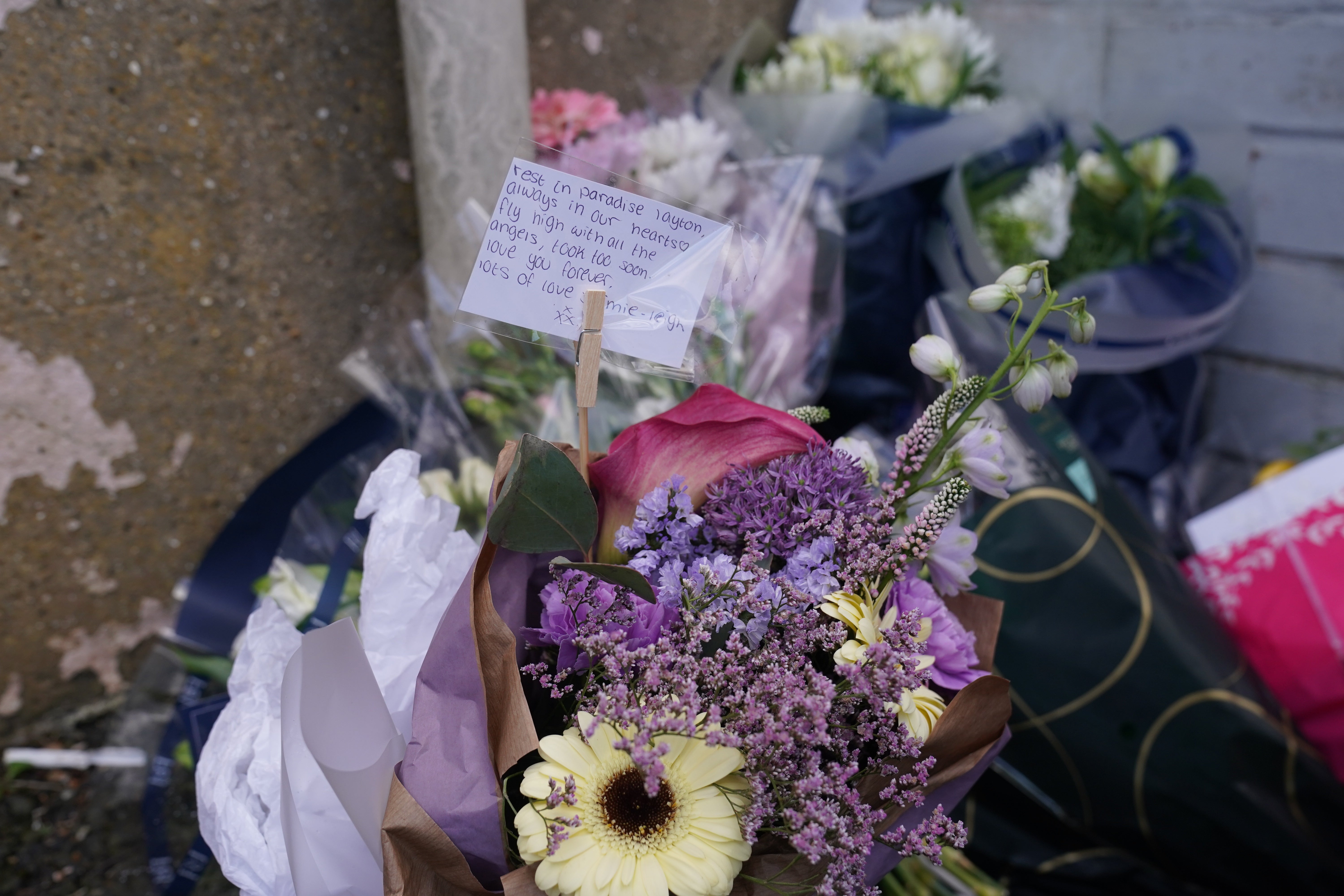 Floral tributes left by the gates of Fairfield Industrial Park(Owen Humphreys/PA)