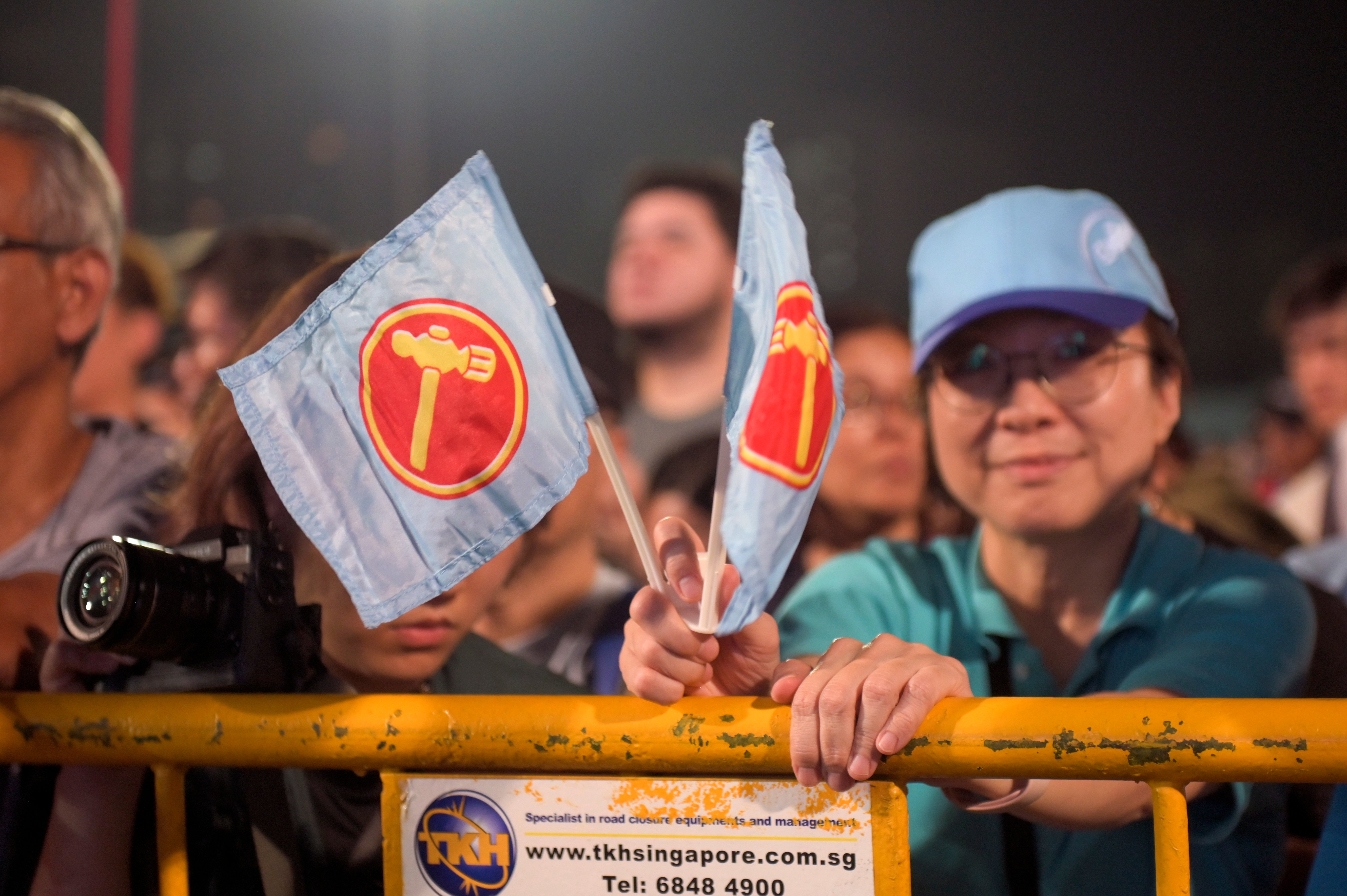 Supporters of the leader of the opposition and secretary-general of the Workers' Party, Pritam Singh, react as he delivers his speech after the preliminary results of the general elections were announced