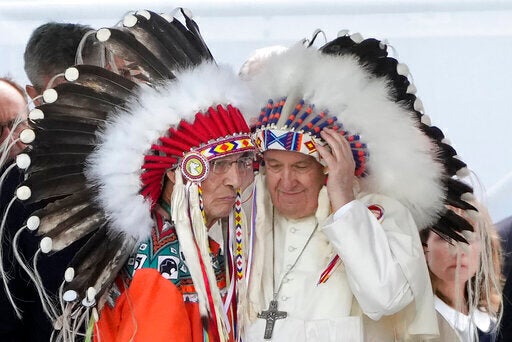 Pope Francis dons a headdress during a meeting with Indigenous communities, including First Nations, Metis and Inuit, at Our Lady of Seven Sorrows Catholic Church in Maskwacis, near Edmonton, Canada, in July 2022