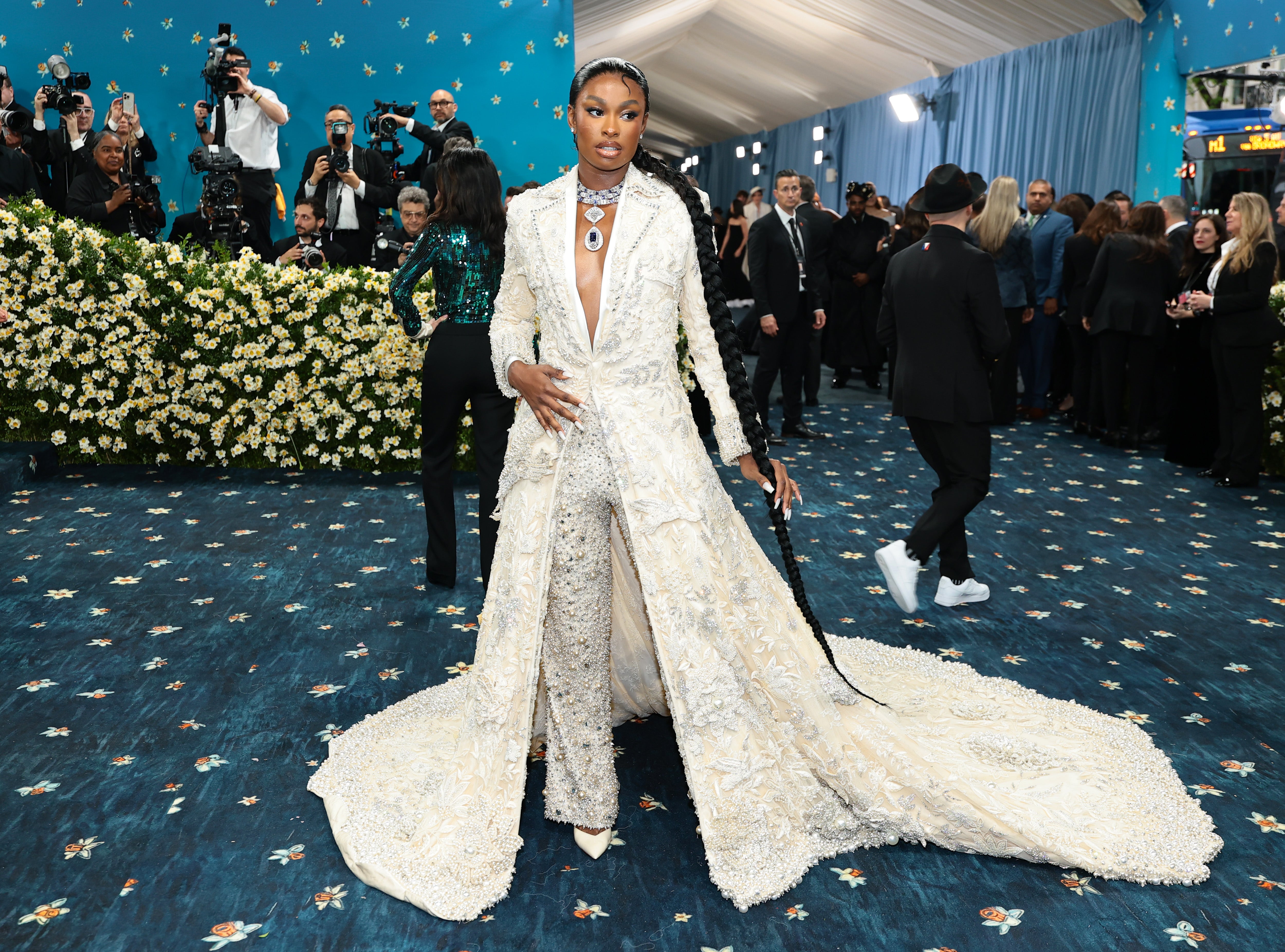 Jones’ jacket featured a floor-length train. She also had her hair in a long braid and her nails painted white