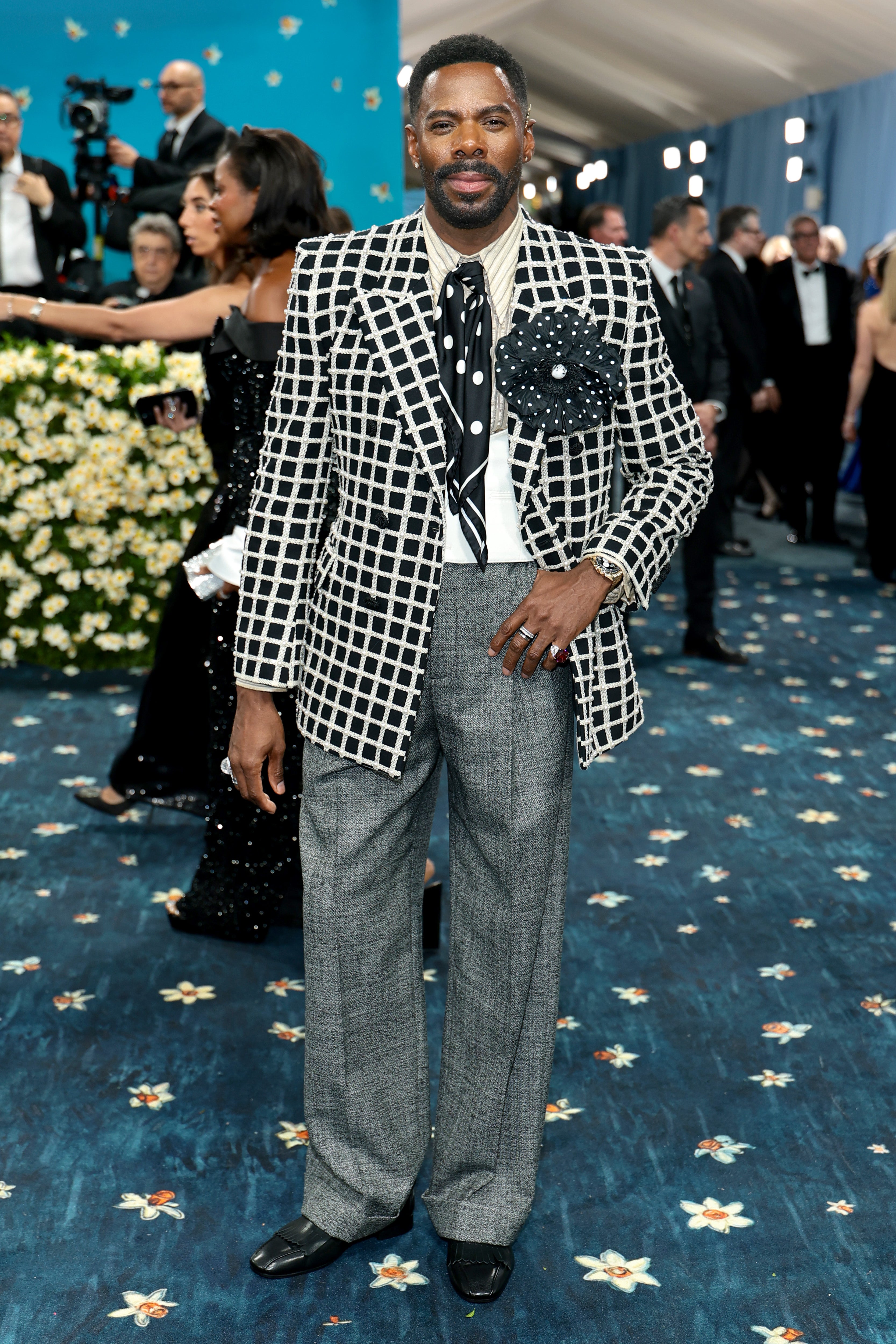 The ‘Four Seasons’ star had an outfit change on the red carpet. His second look was a white and black striped jacket, with a black rose-shaped pin on it. The outfit was complemented by a polka dot tie