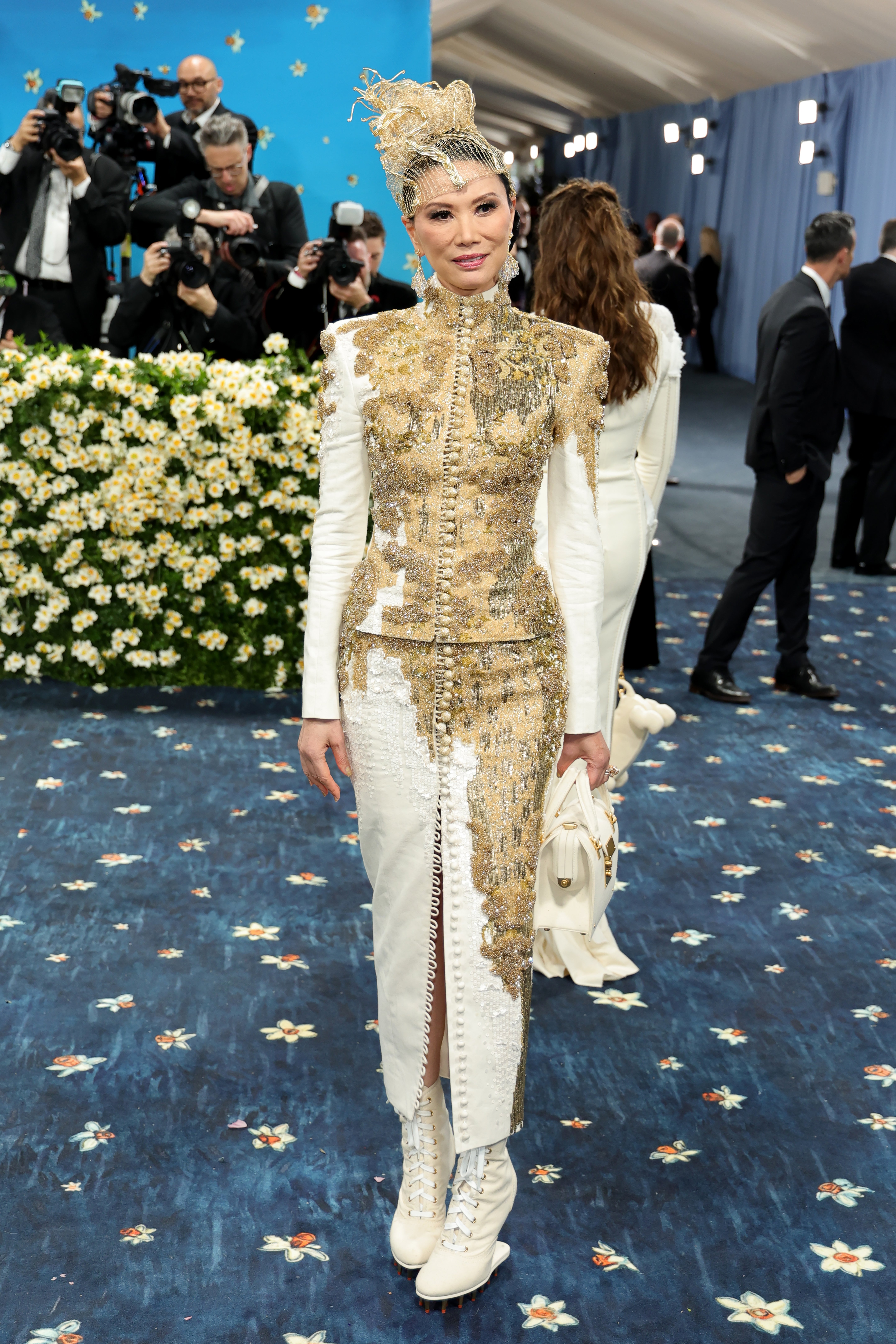 Socialite Wendi Murdoch arrived to the Met in a custom Thom Browne ensemble with intricate gold embroidery throughout and a netted headpiece