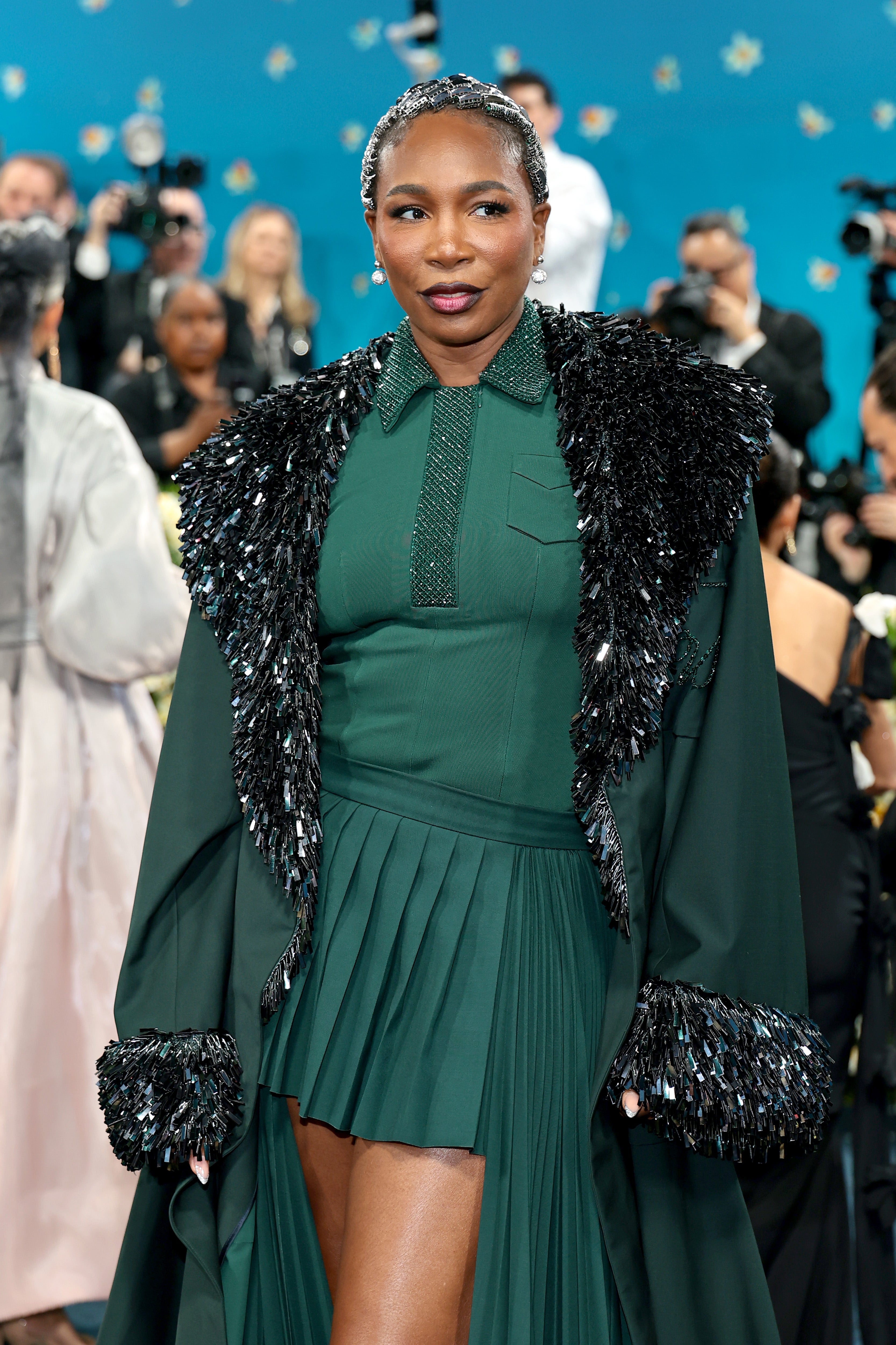 The 44-year-old athlete drew inspiration from the sport attire while juxtaposing uniform silhouette with a long overcoat that seemed more suitable for the holiday season